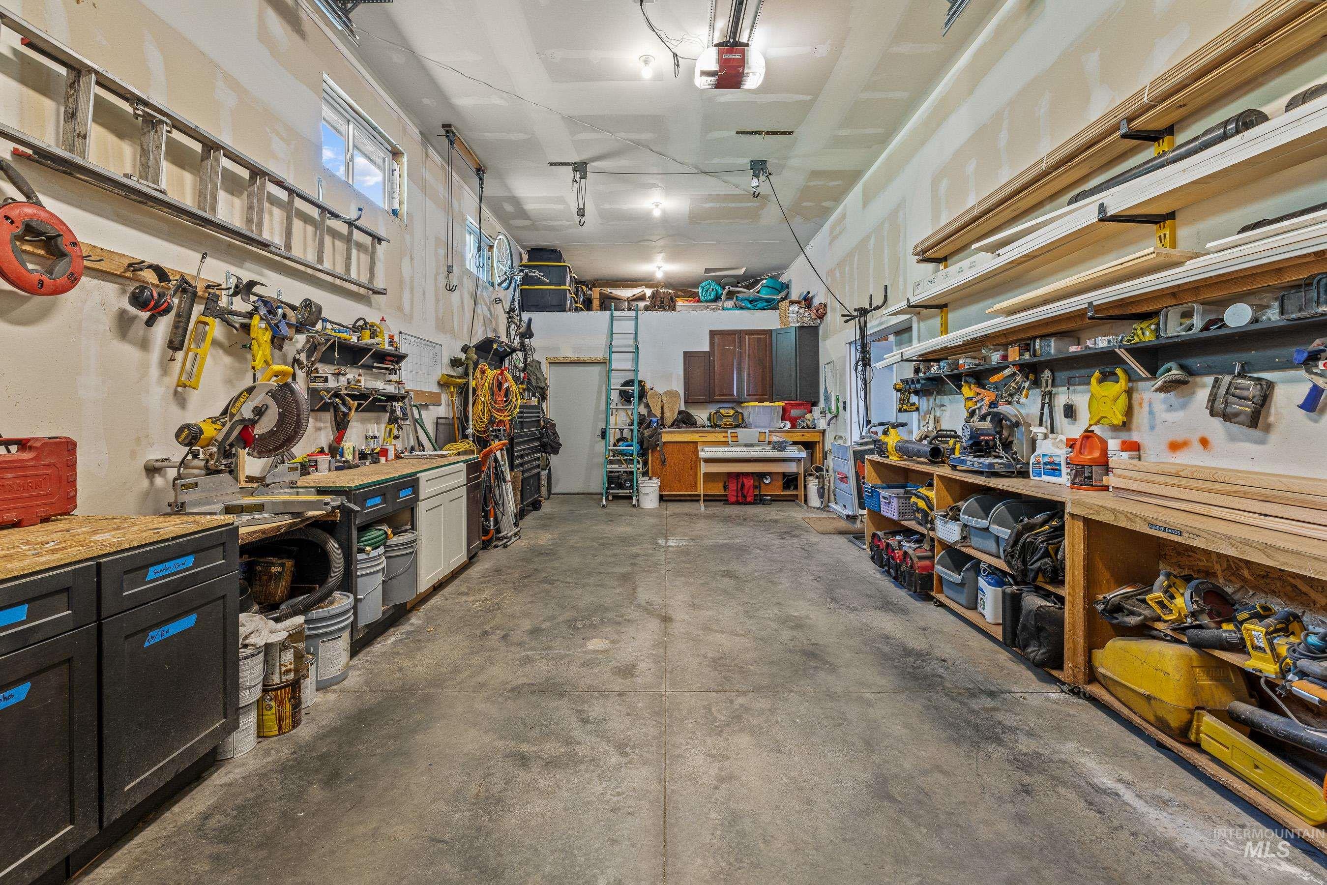 Garage with a workshop area and a garage door opener