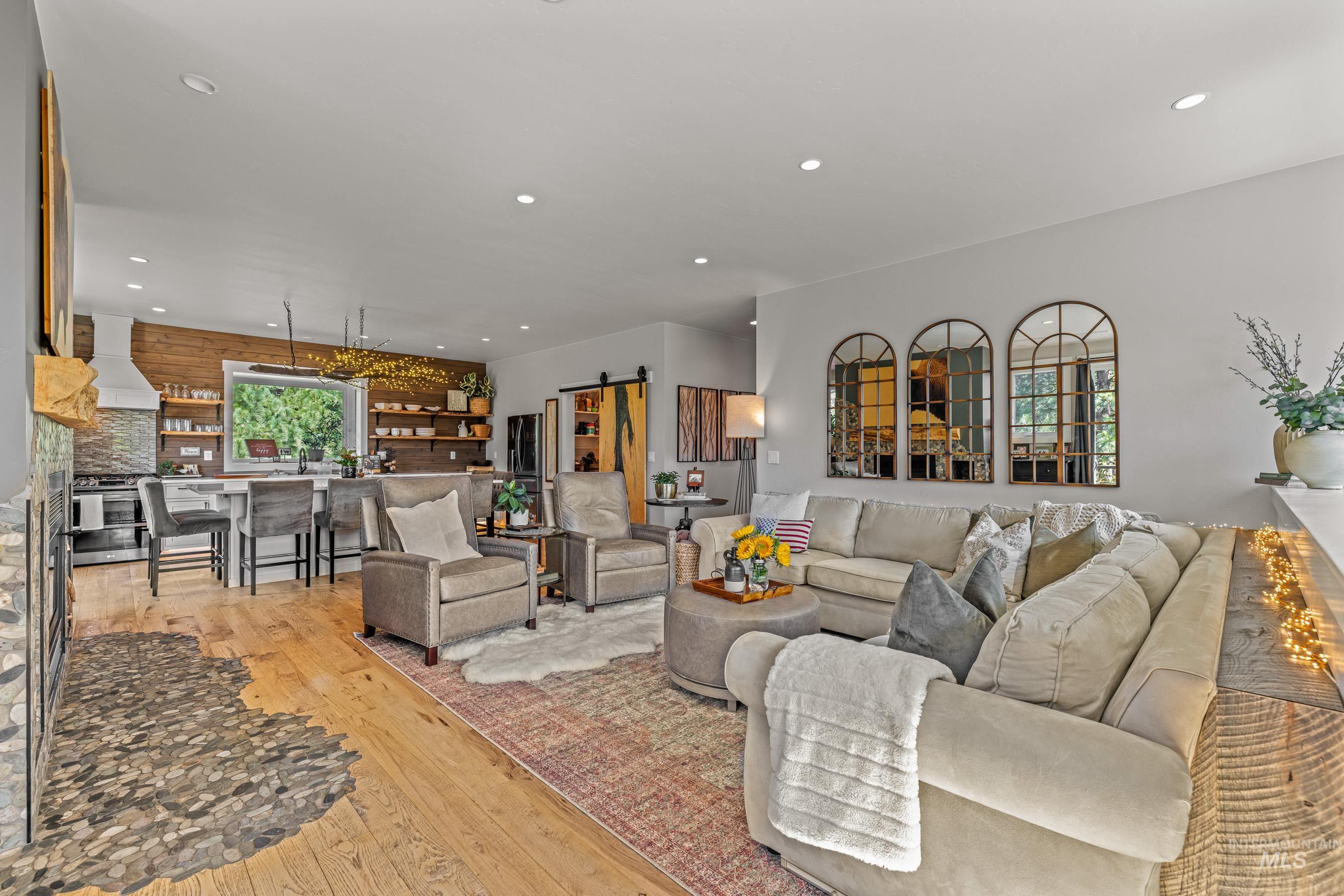 Living area with recessed lighting, a barn door, and hardwood / wood-style floors