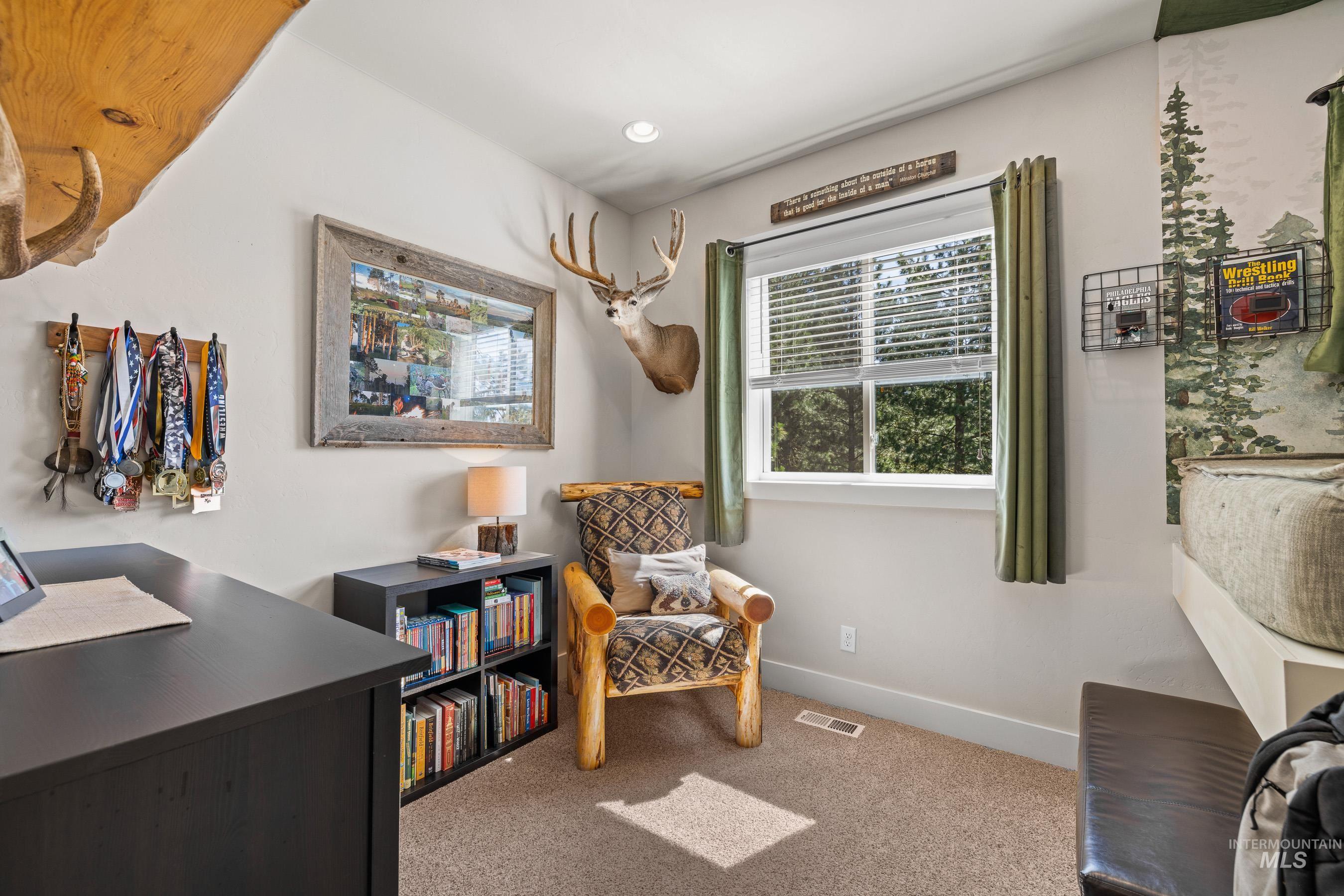 Living area featuring light colored carpet, recessed lighting, and an office area