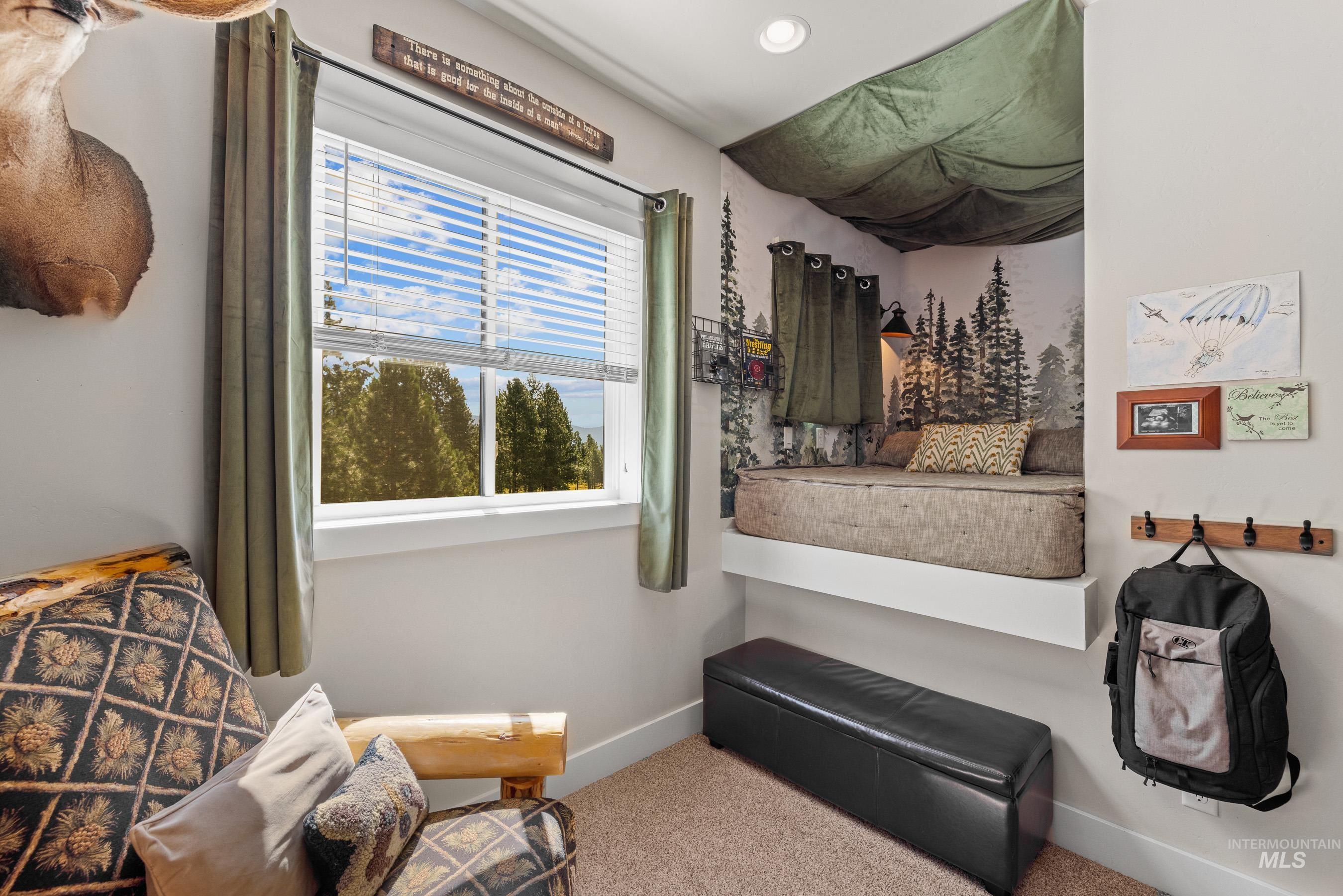 Carpeted bedroom featuring baseboards