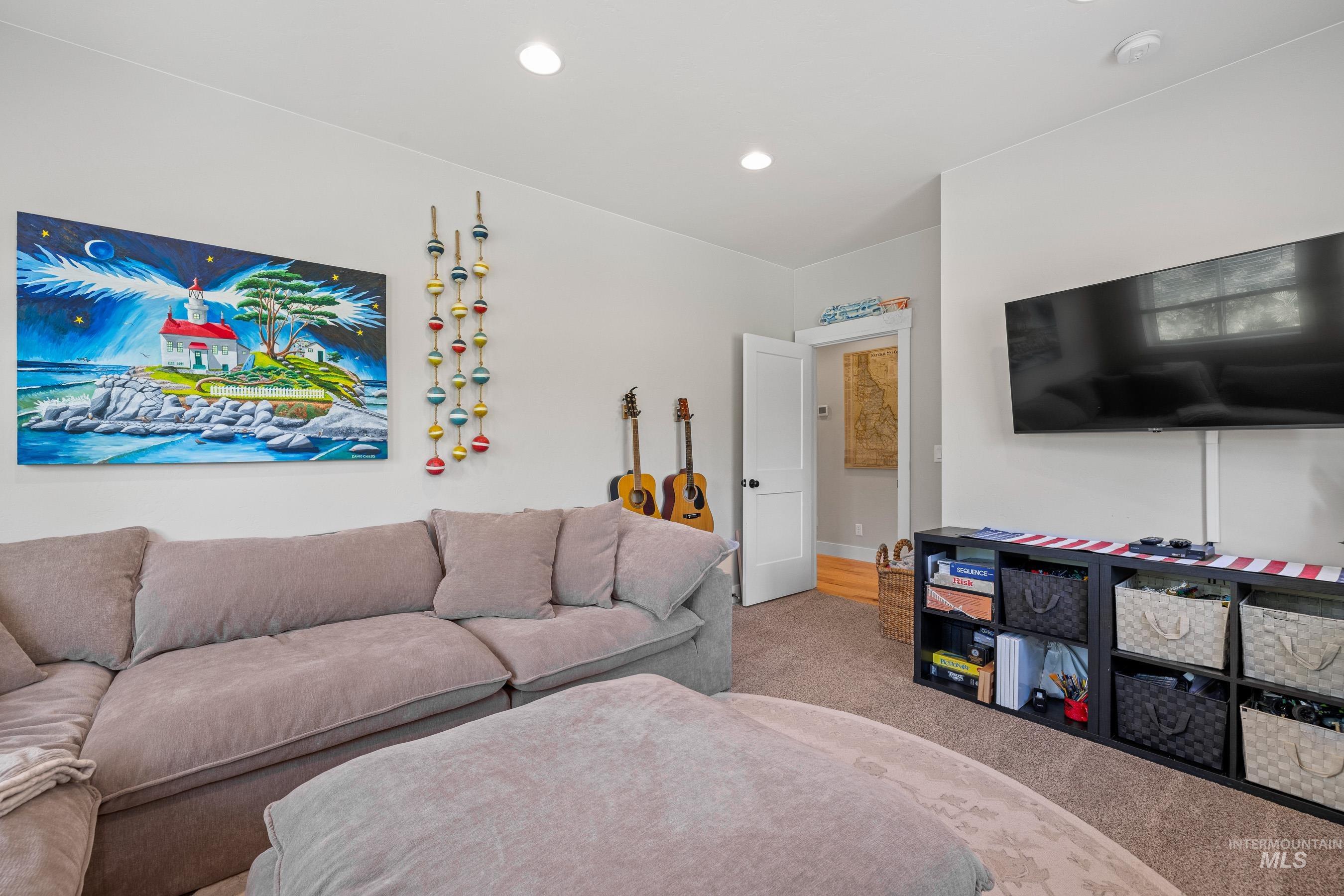 Carpeted living area featuring baseboards and recessed lighting