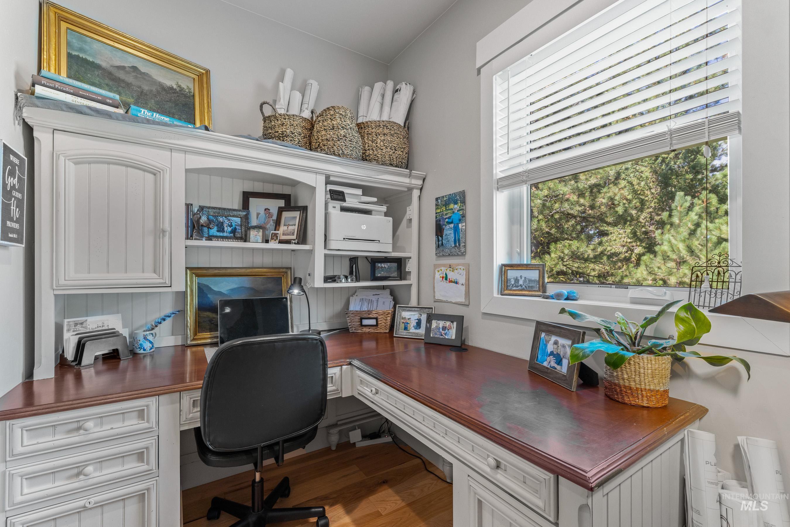 Office with built in study area and wood finished floors