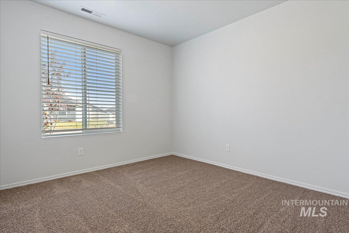 Unfurnished room featuring carpet and baseboards