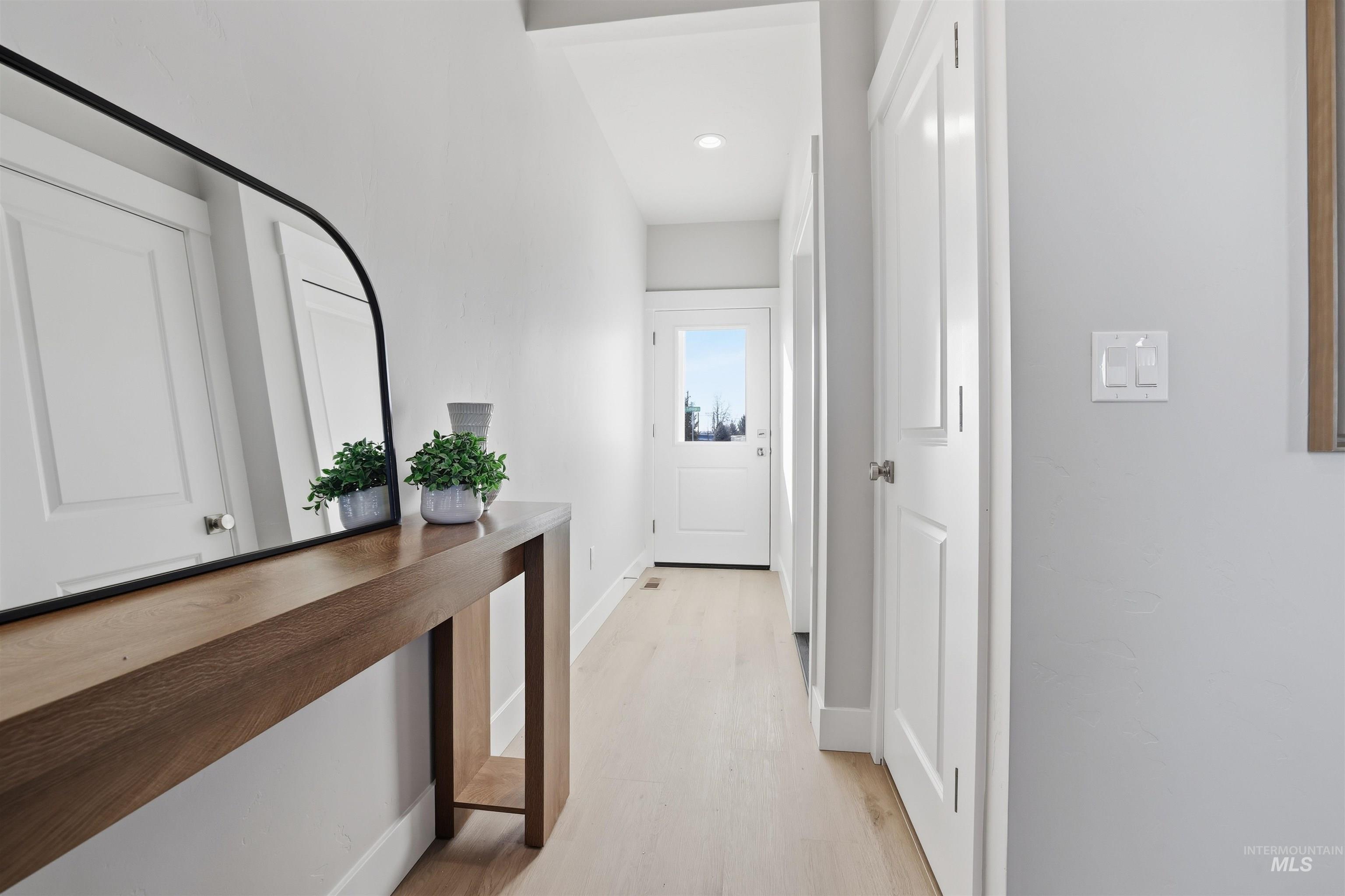 Hall featuring baseboards and light wood-type flooring