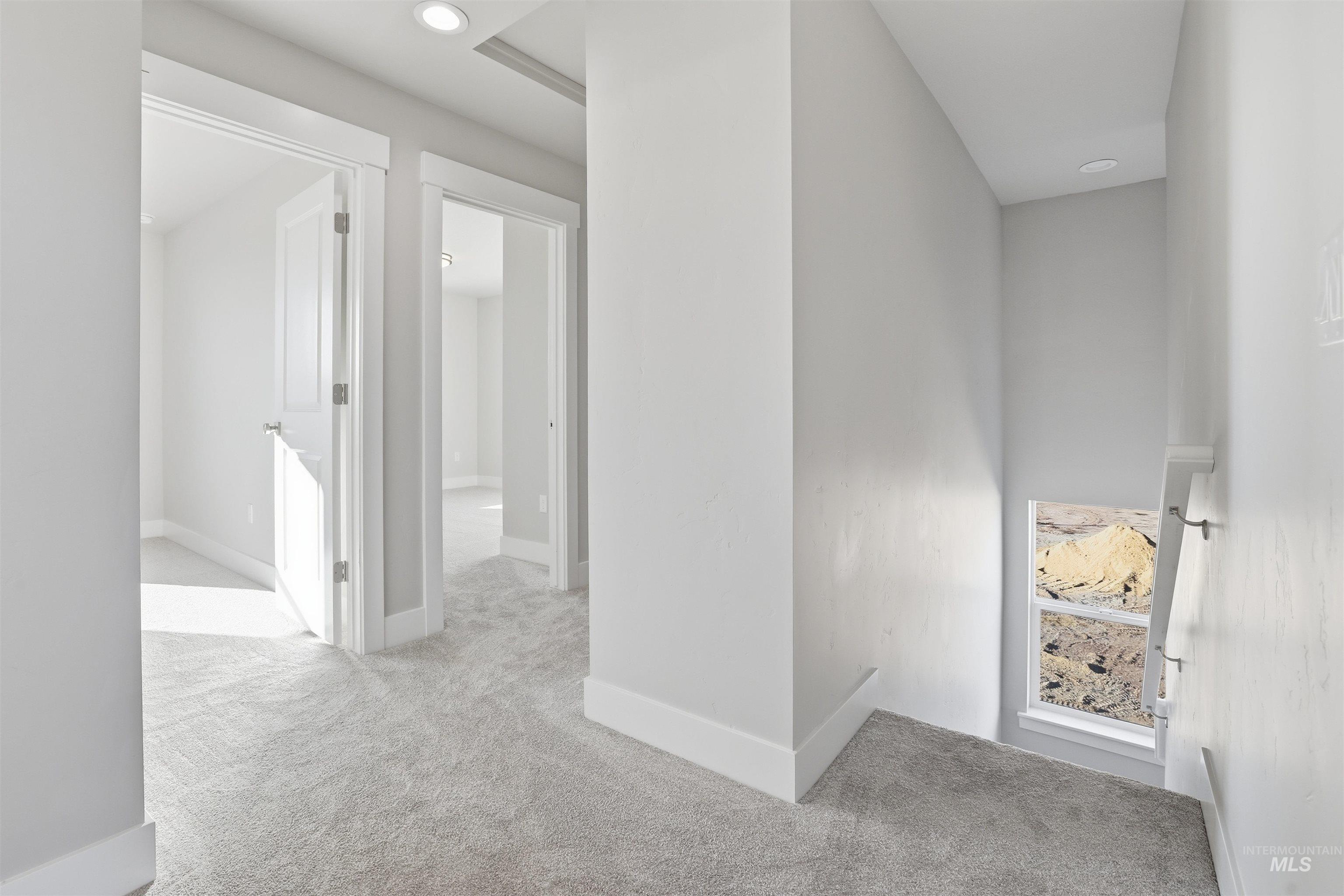 Hall featuring carpet, recessed lighting, and an upstairs landing