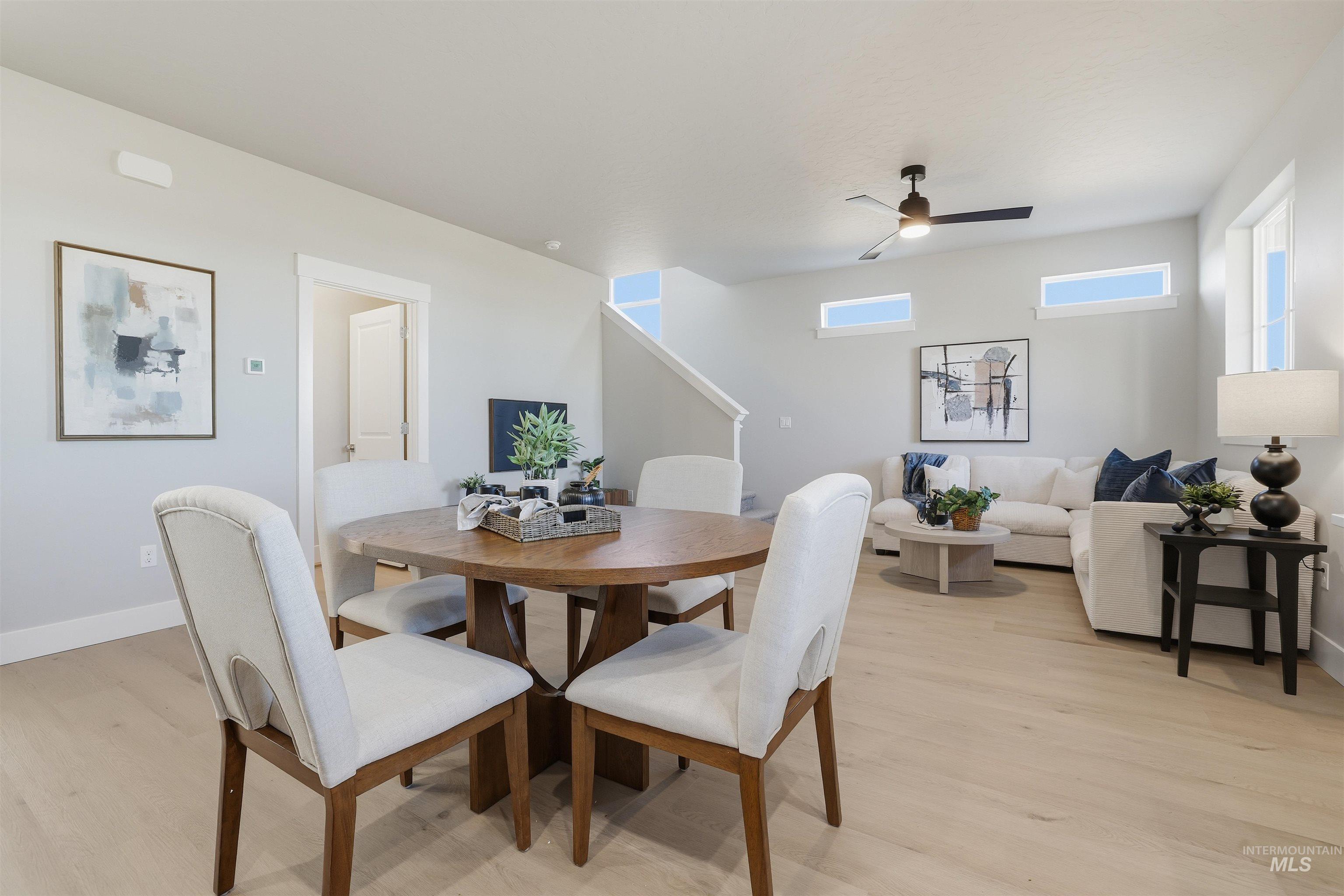 Dining area with light wood finished floors and a ceiling fan
