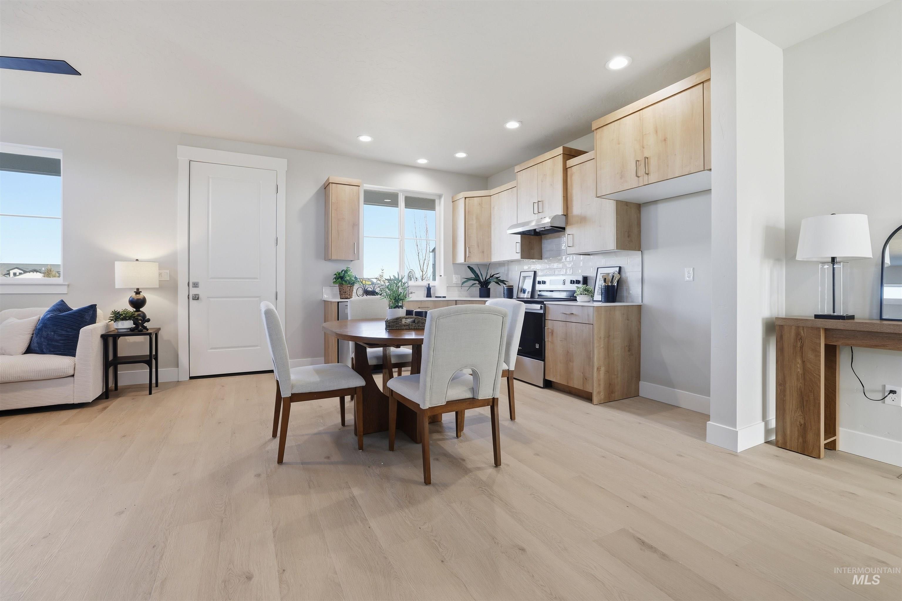 Dining area featuring light wood-style floors and recessed lighting