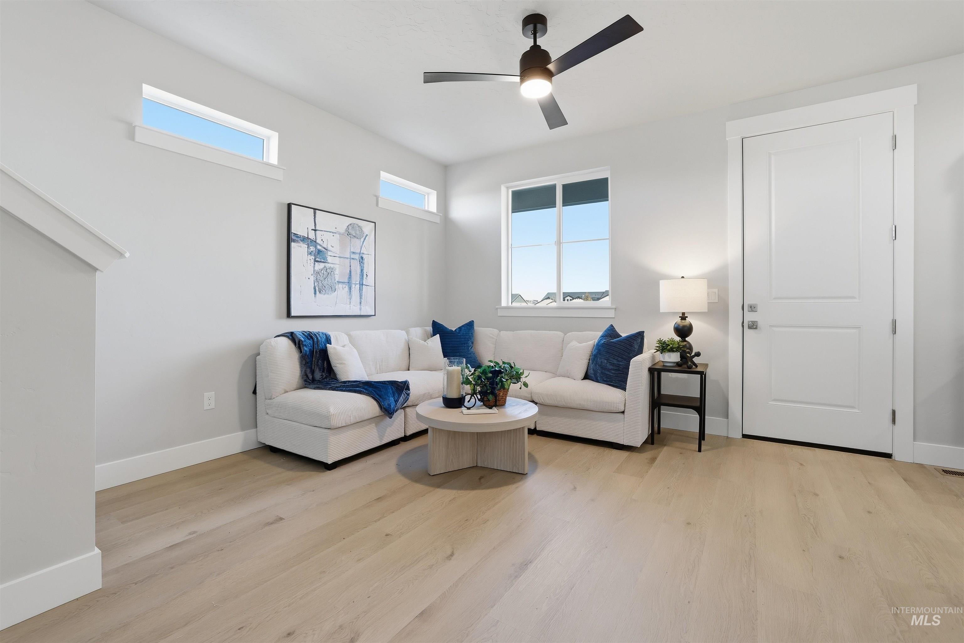 Living room featuring light wood-style floors and ceiling fan