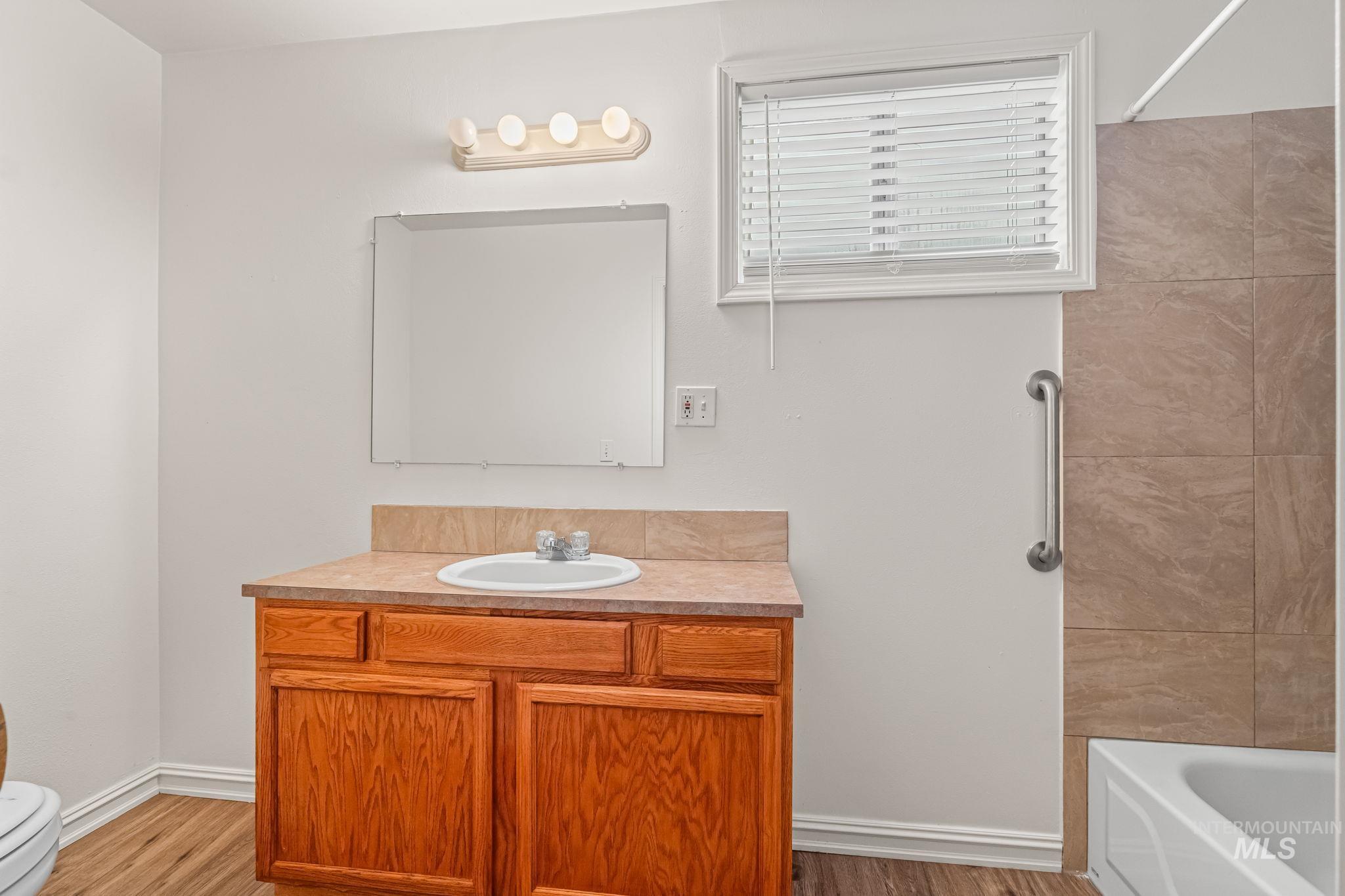 Bathroom featuring vanity and light wood finished floors
