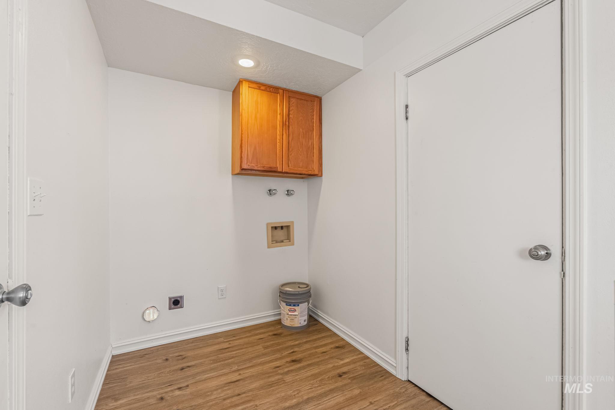 Laundry area featuring washer hookup, light wood finished floors, cabinet space, hookup for an electric dryer, and recessed lighting