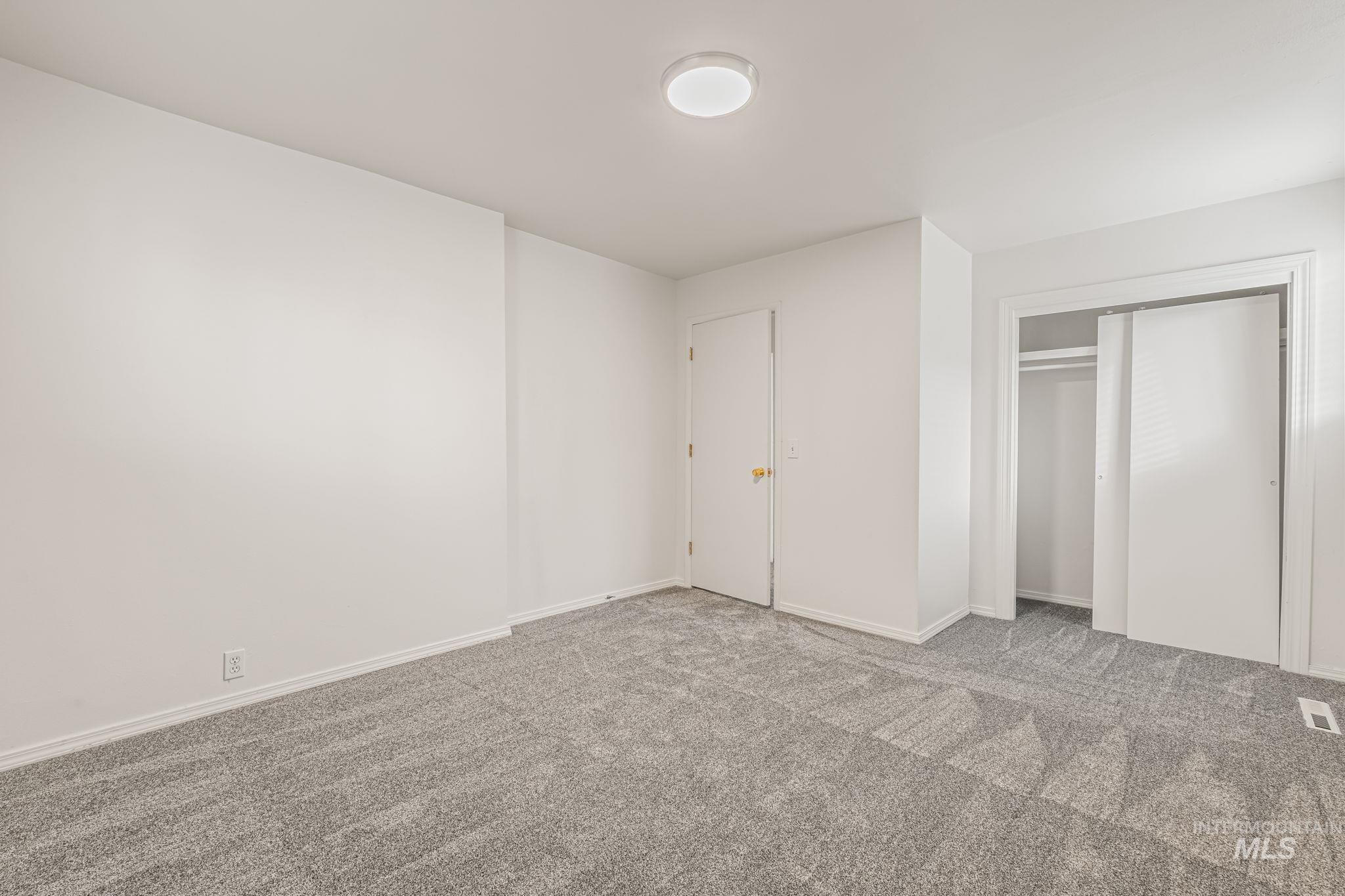 Unfurnished bedroom with carpet floors and a closet