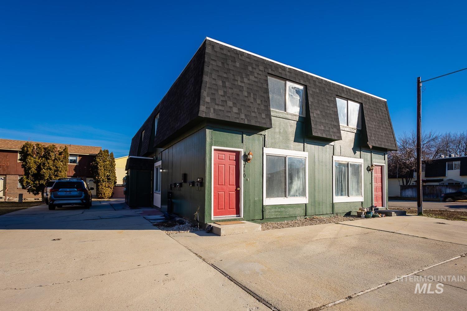 View of front of house with a shingled roof and mansard roof