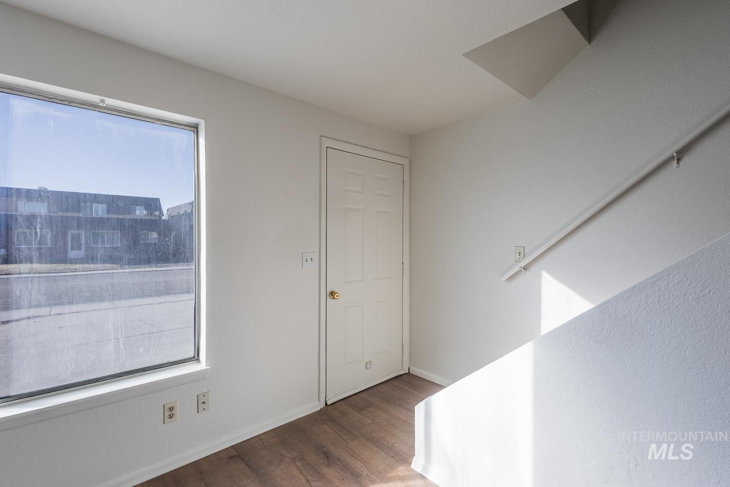 Entrance foyer with wood finished floors and baseboards