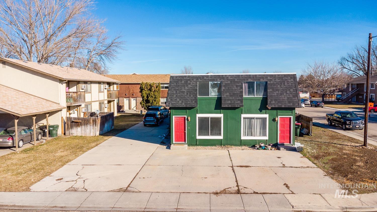 View of front of house with a shingled roof, mansard roof, and a residential view
