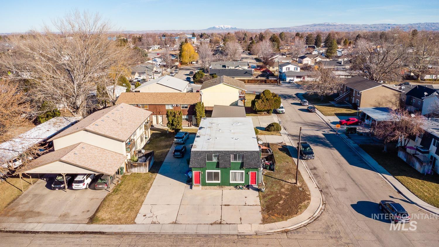 Aerial view of residential area featuring a mountain backdrop