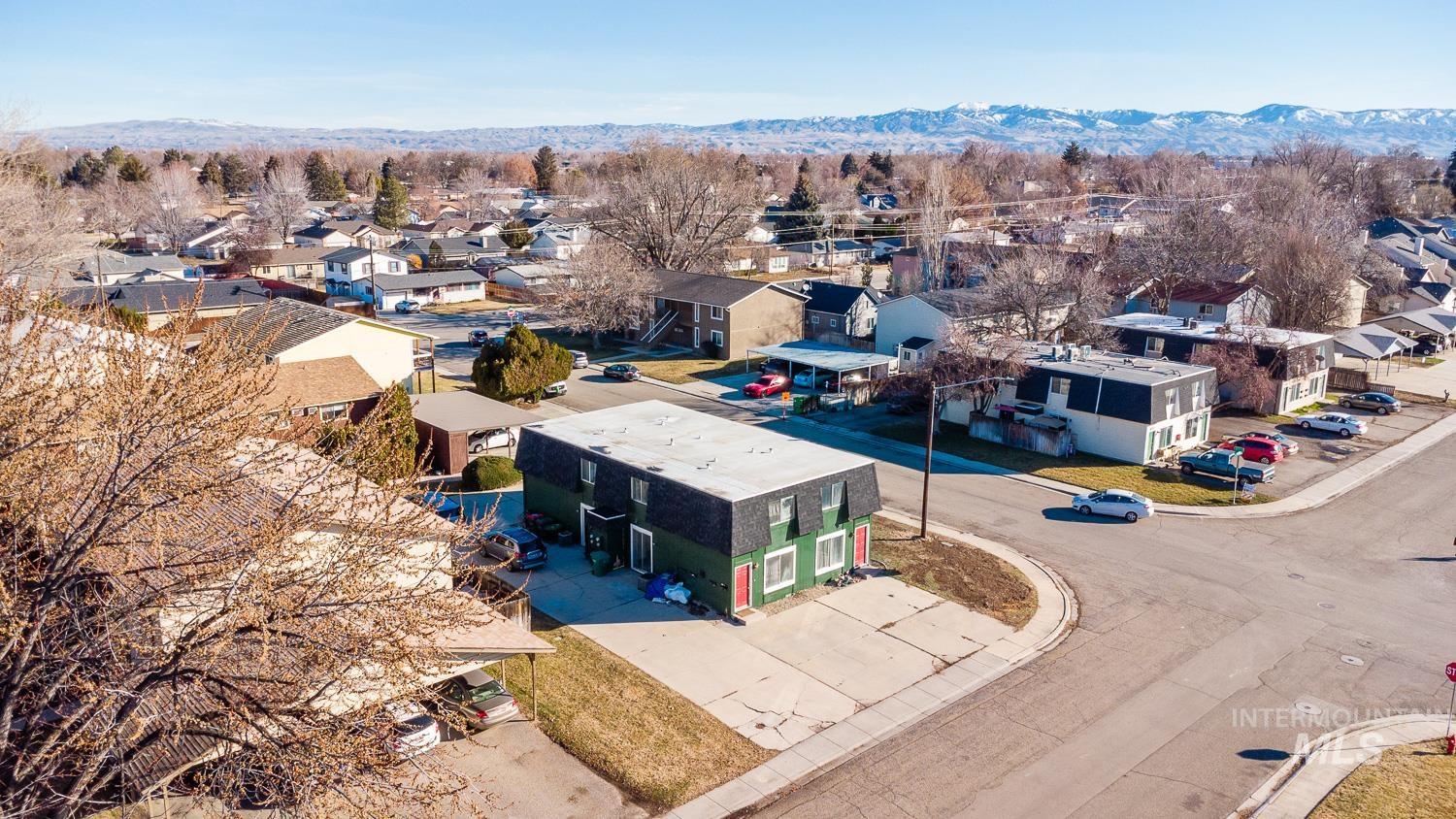 Aerial view of residential area featuring a mountain backdrop