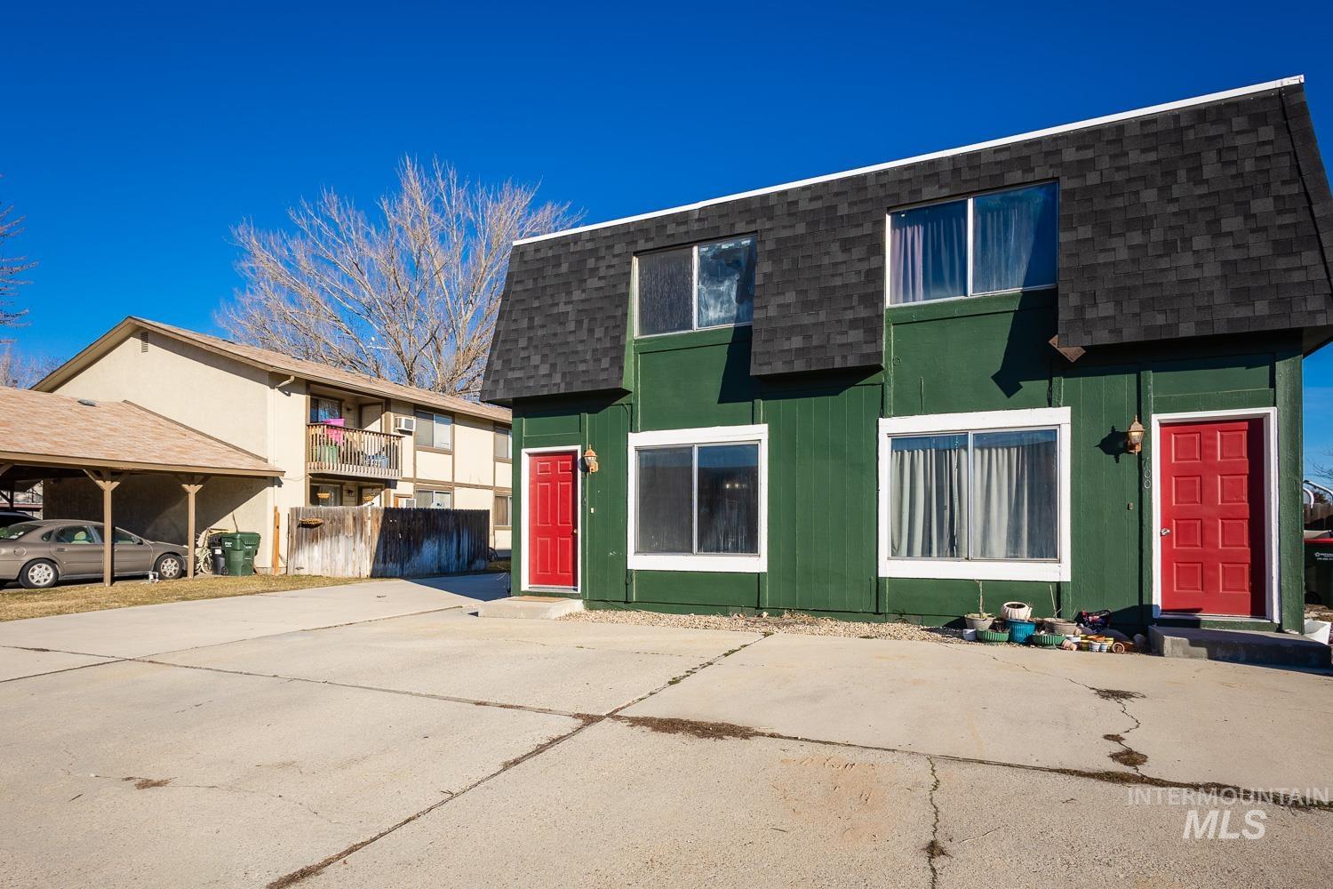 View of front facade featuring a shingled roof and mansard roof