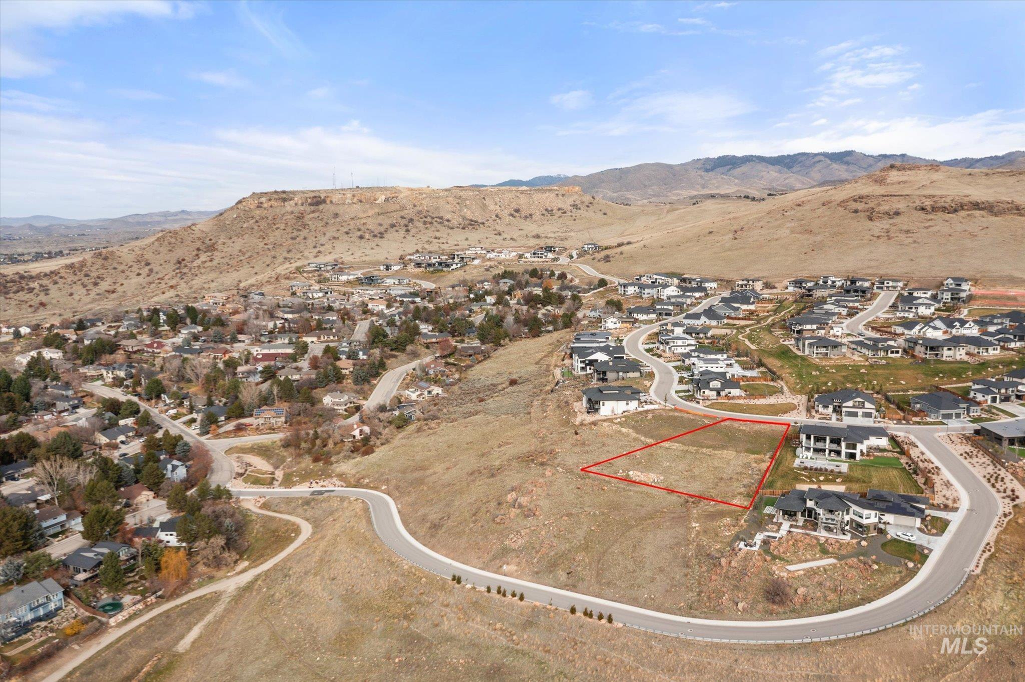 View of property location with a mountainous background and nearby suburban area