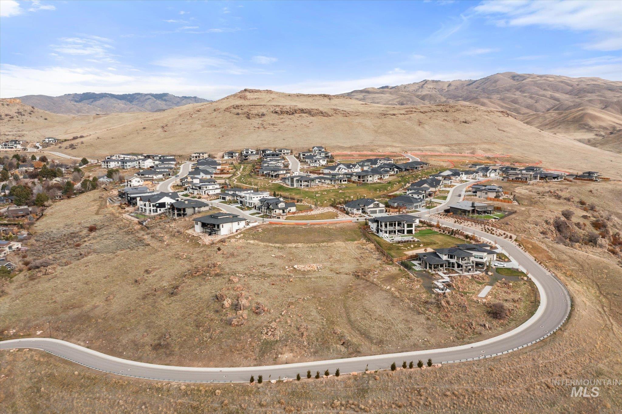 View of property location with a mountain backdrop and nearby suburban area