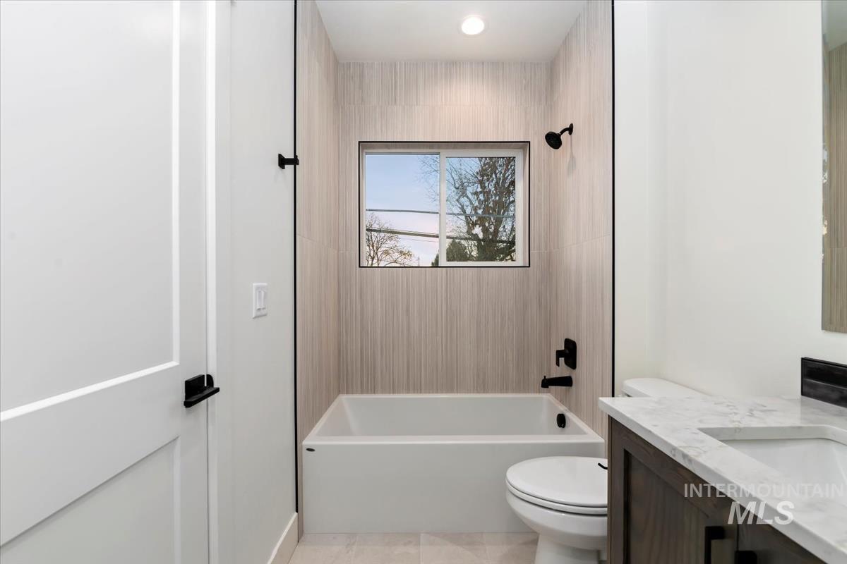 Bathroom with vanity and shower / washtub combination