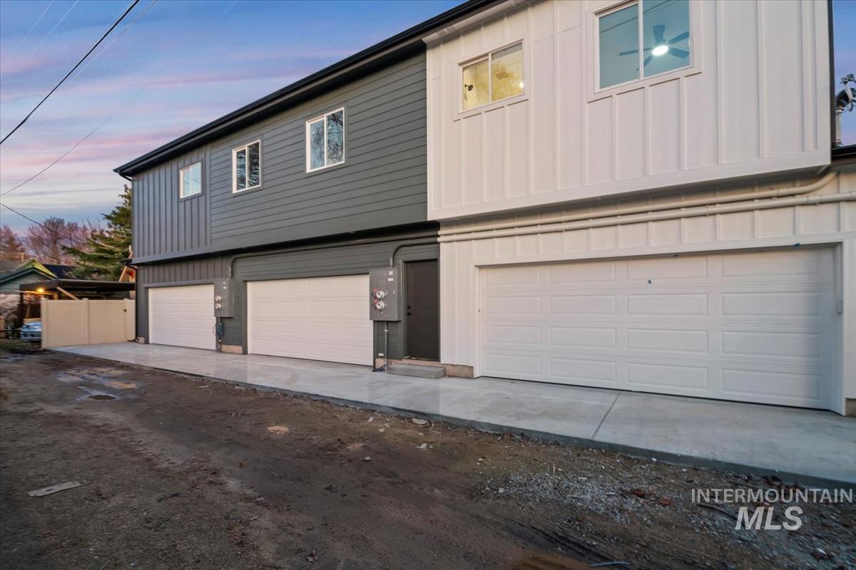Property exterior at dusk featuring board and batten siding and a garage