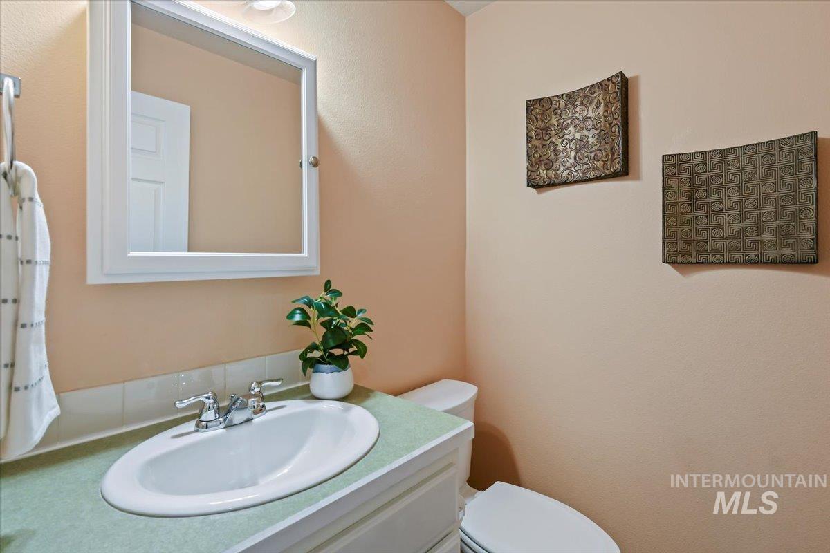 Half bathroom with vanity and toilet