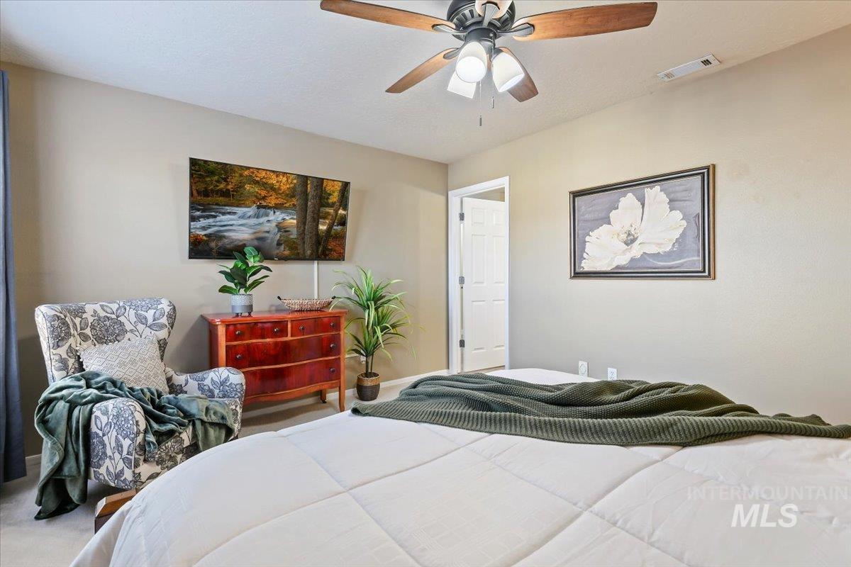Bedroom with ceiling fan and carpet flooring