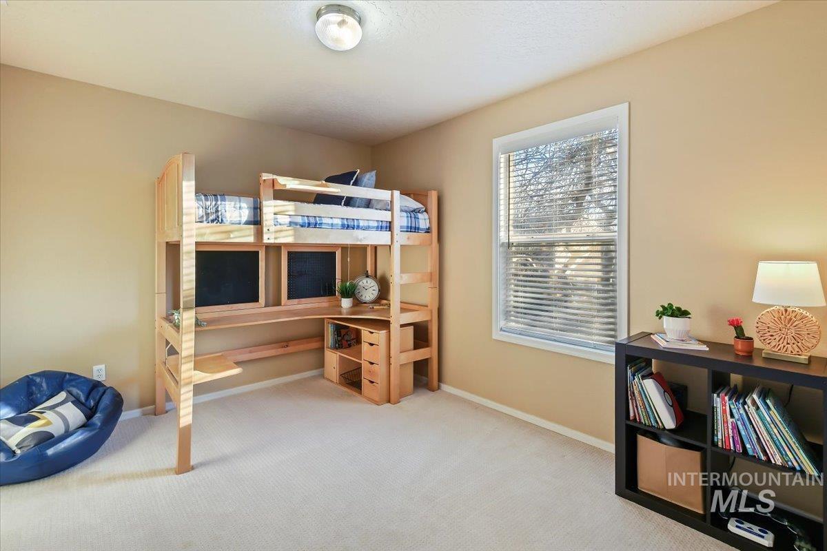 Carpeted bedroom with baseboards
