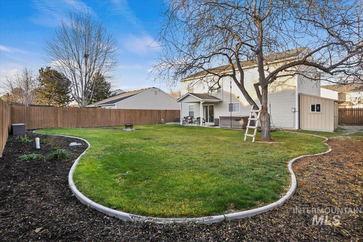 Fenced backyard with a patio