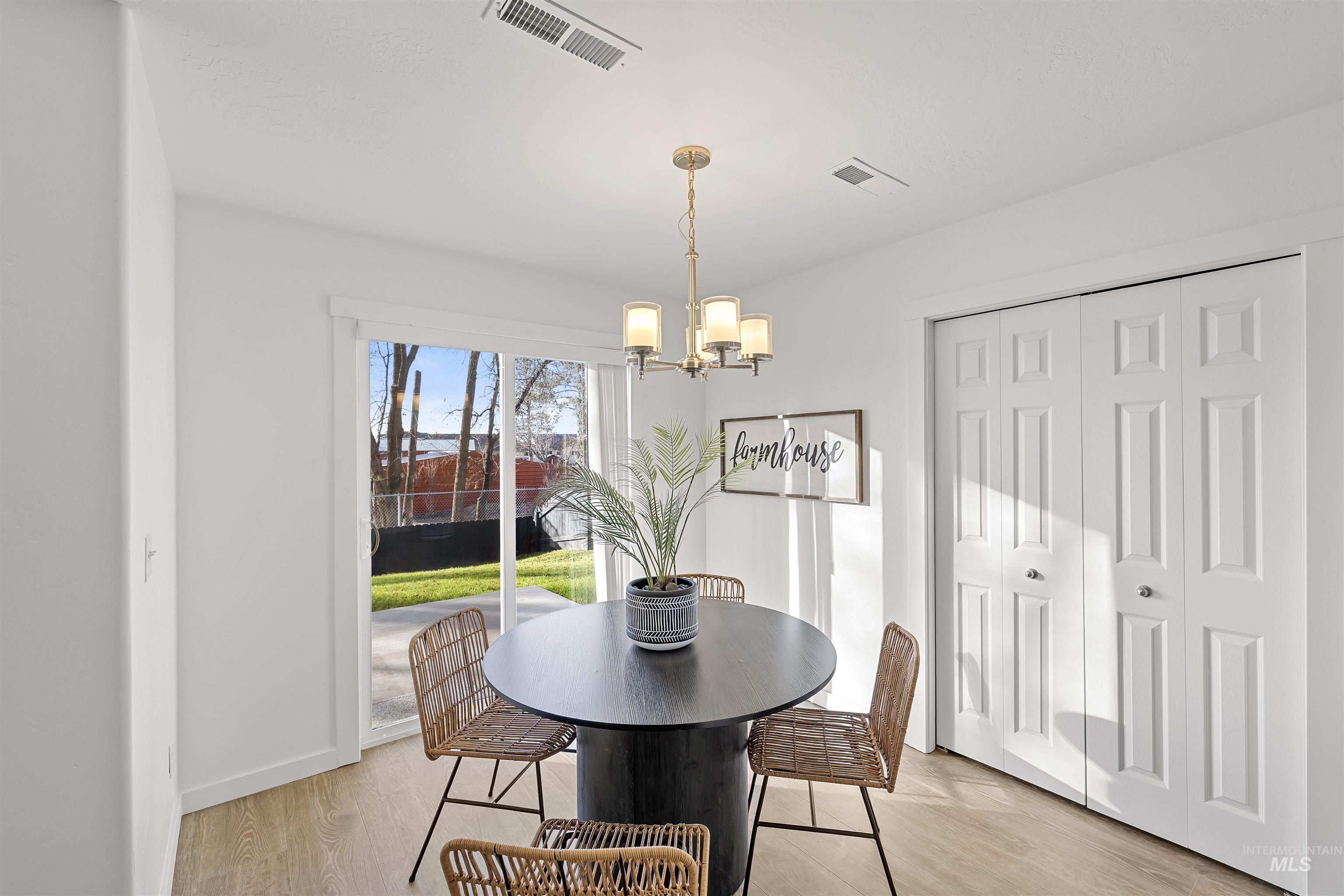 Dining space featuring a chandelier and light wood finished floors