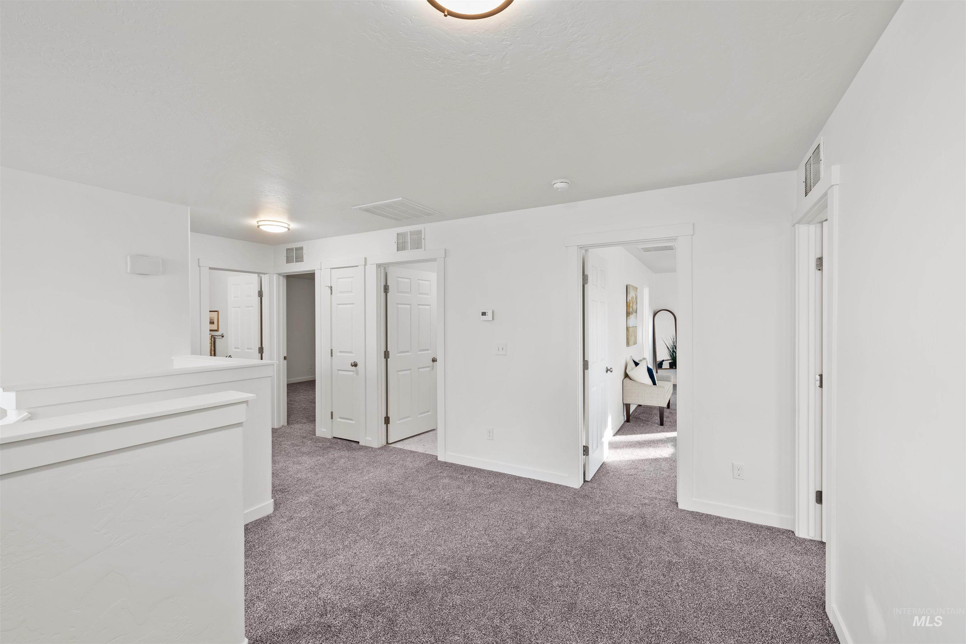 Empty room with carpet and baseboards