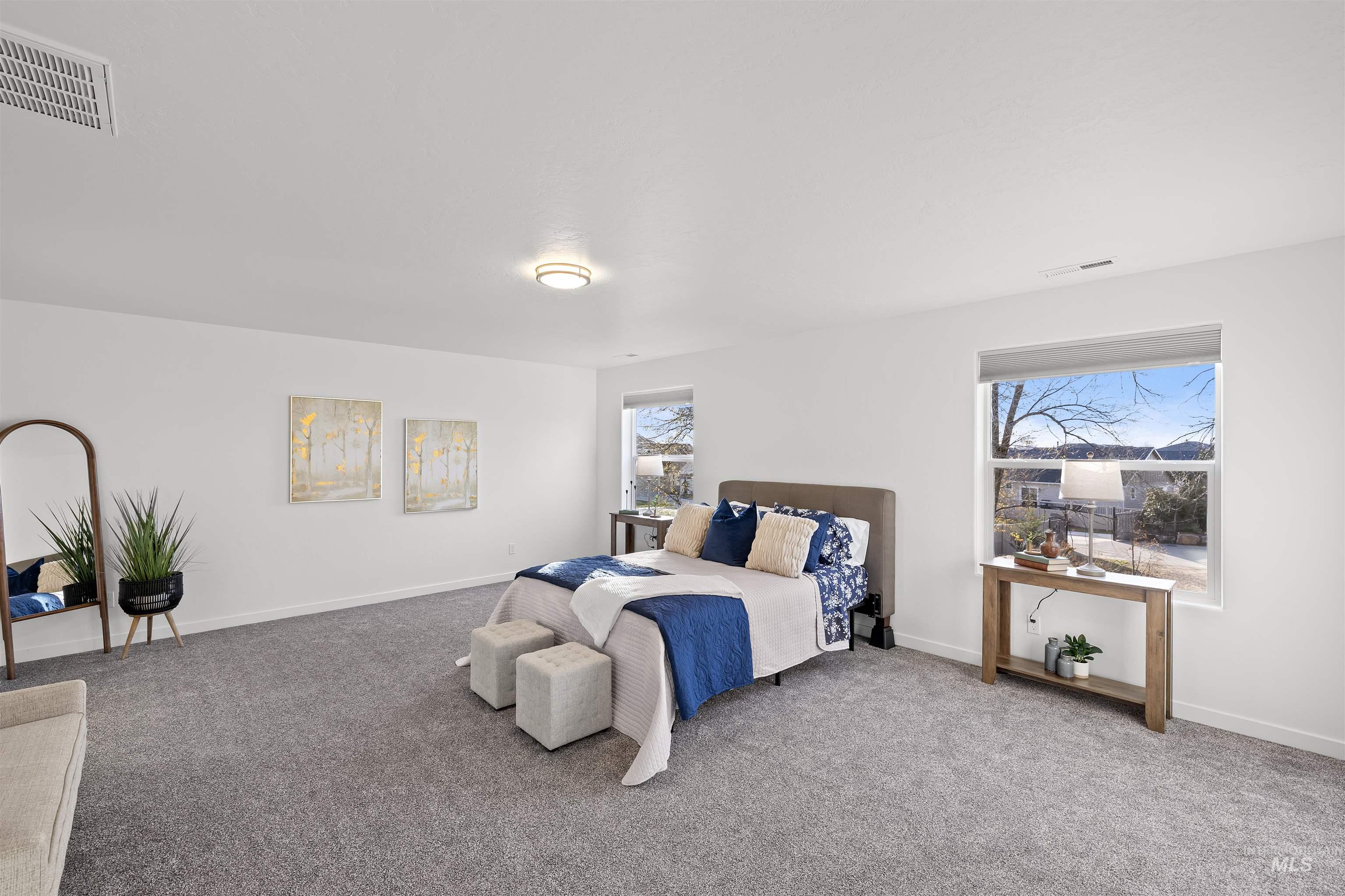 Bedroom featuring carpet flooring and baseboards