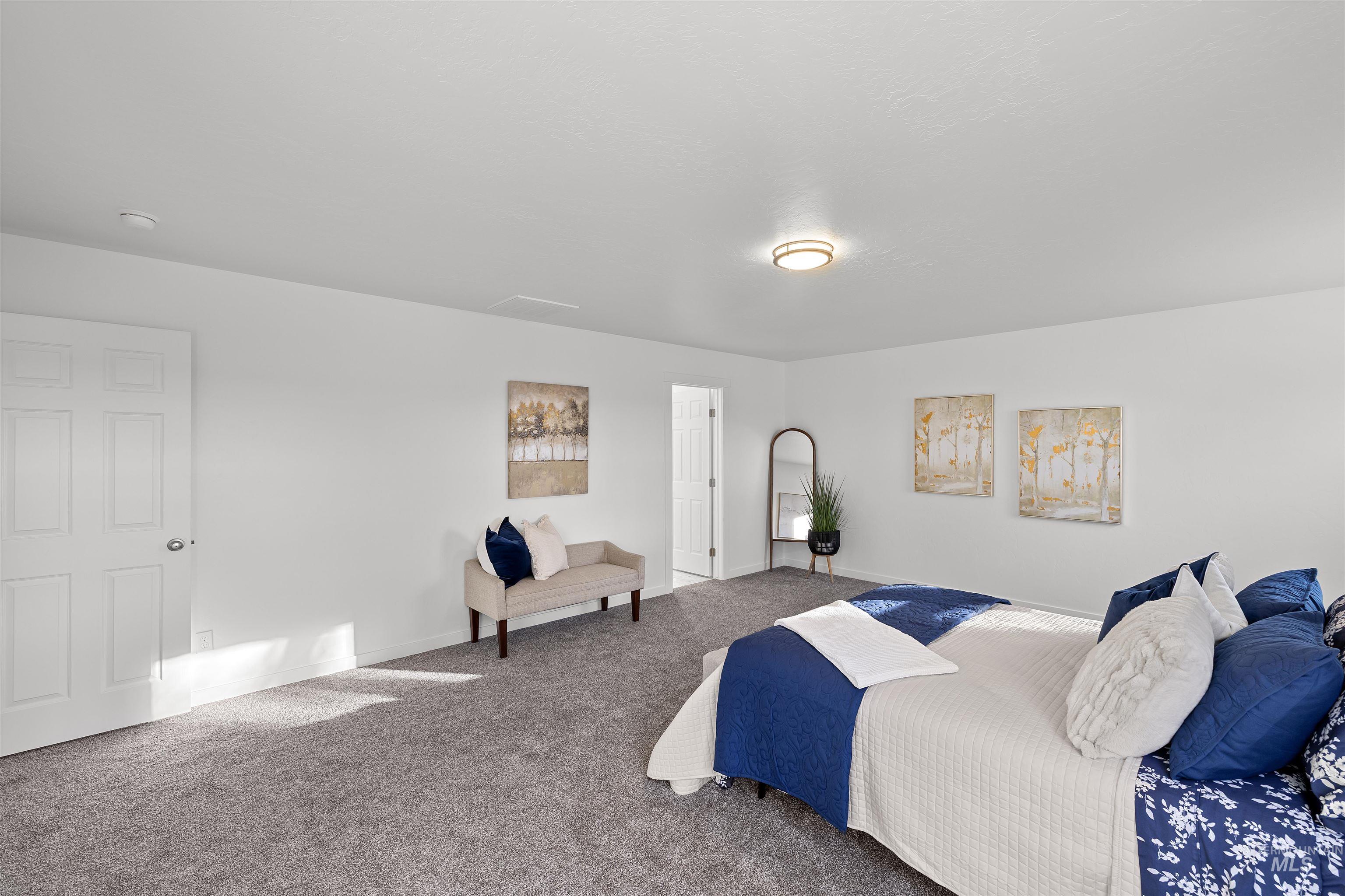 Carpeted bedroom featuring baseboards