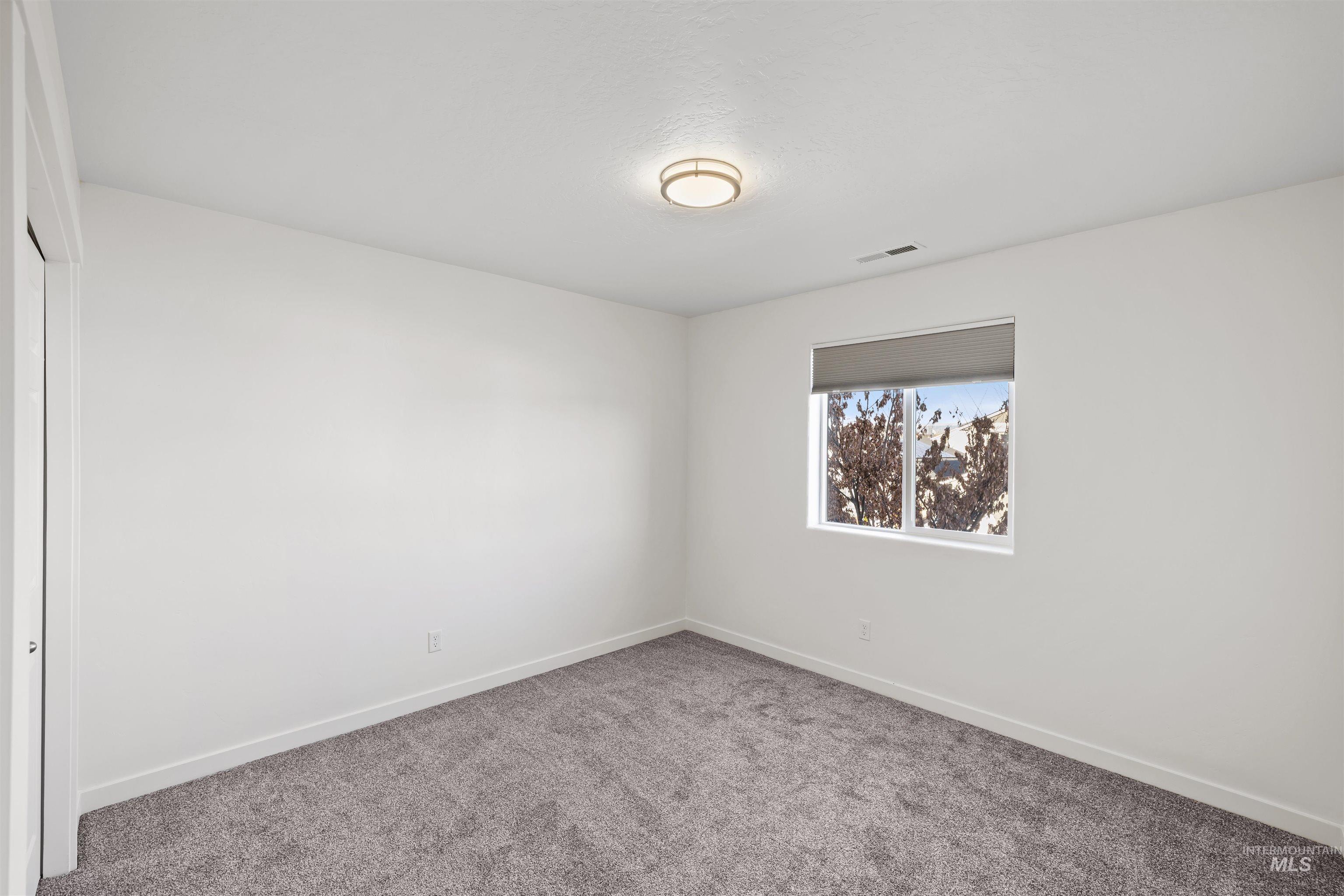 Spare room with carpet flooring and baseboards