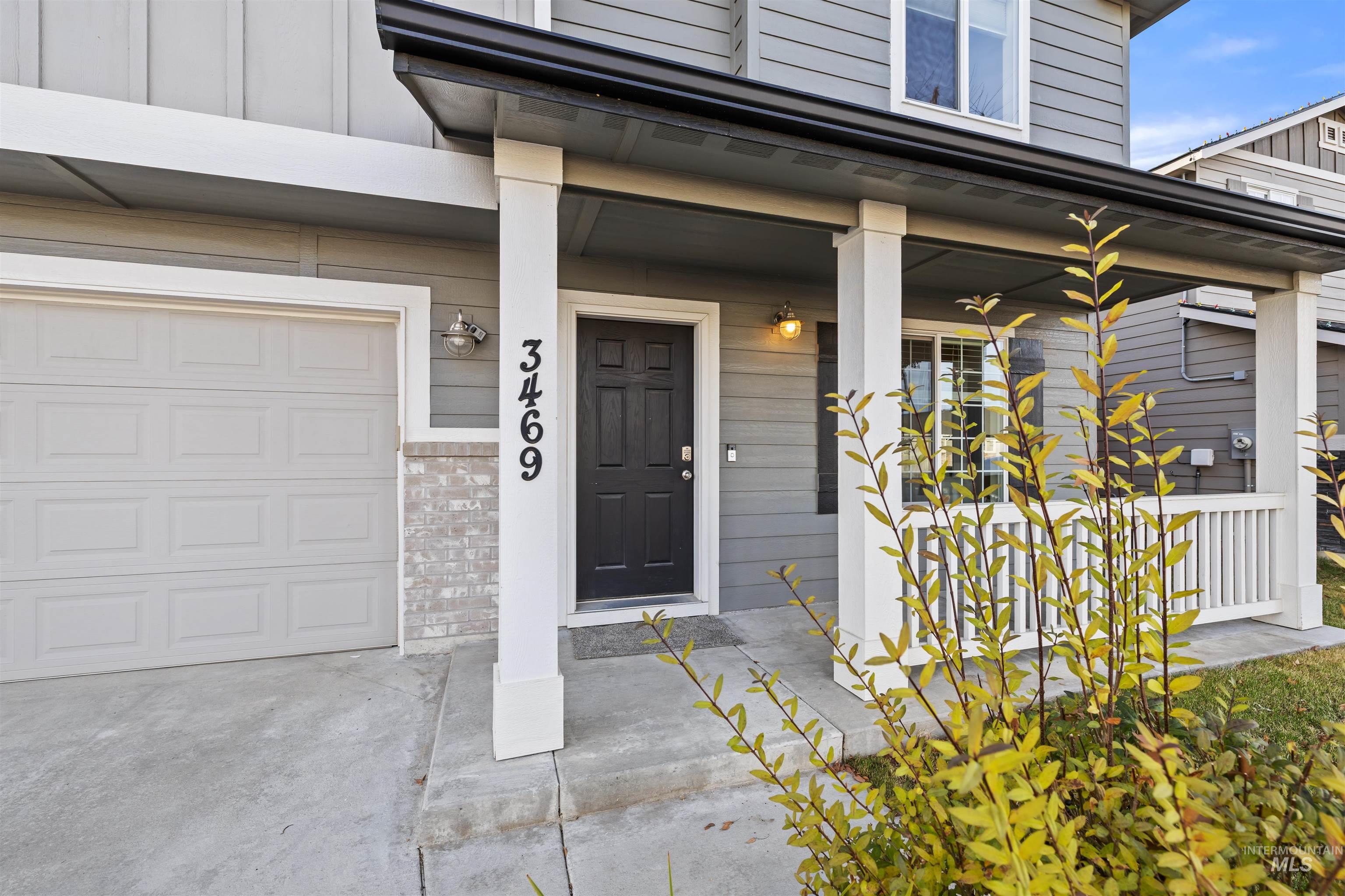 Entrance to property with covered porch and a garage