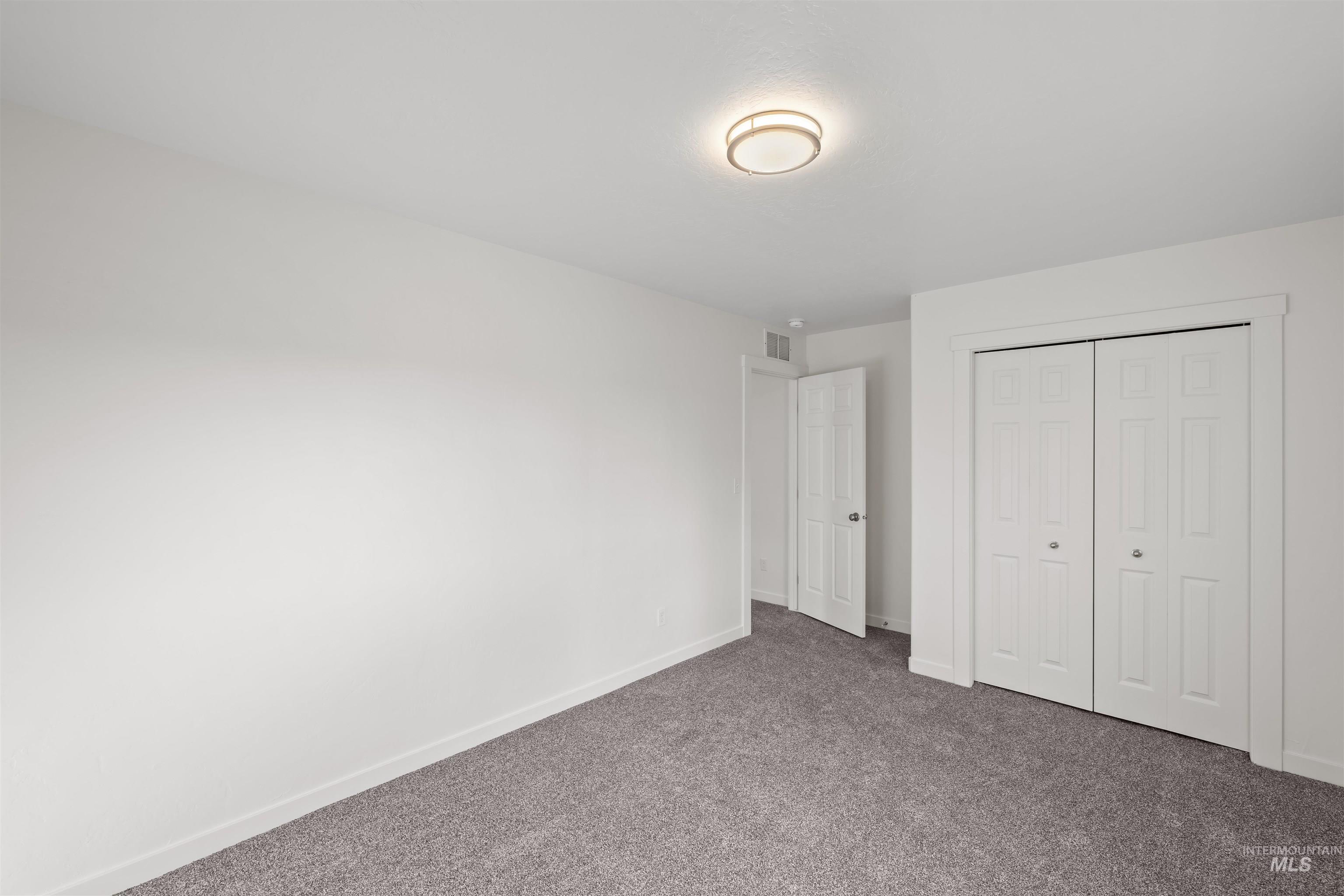 Unfurnished bedroom with carpet floors and a closet