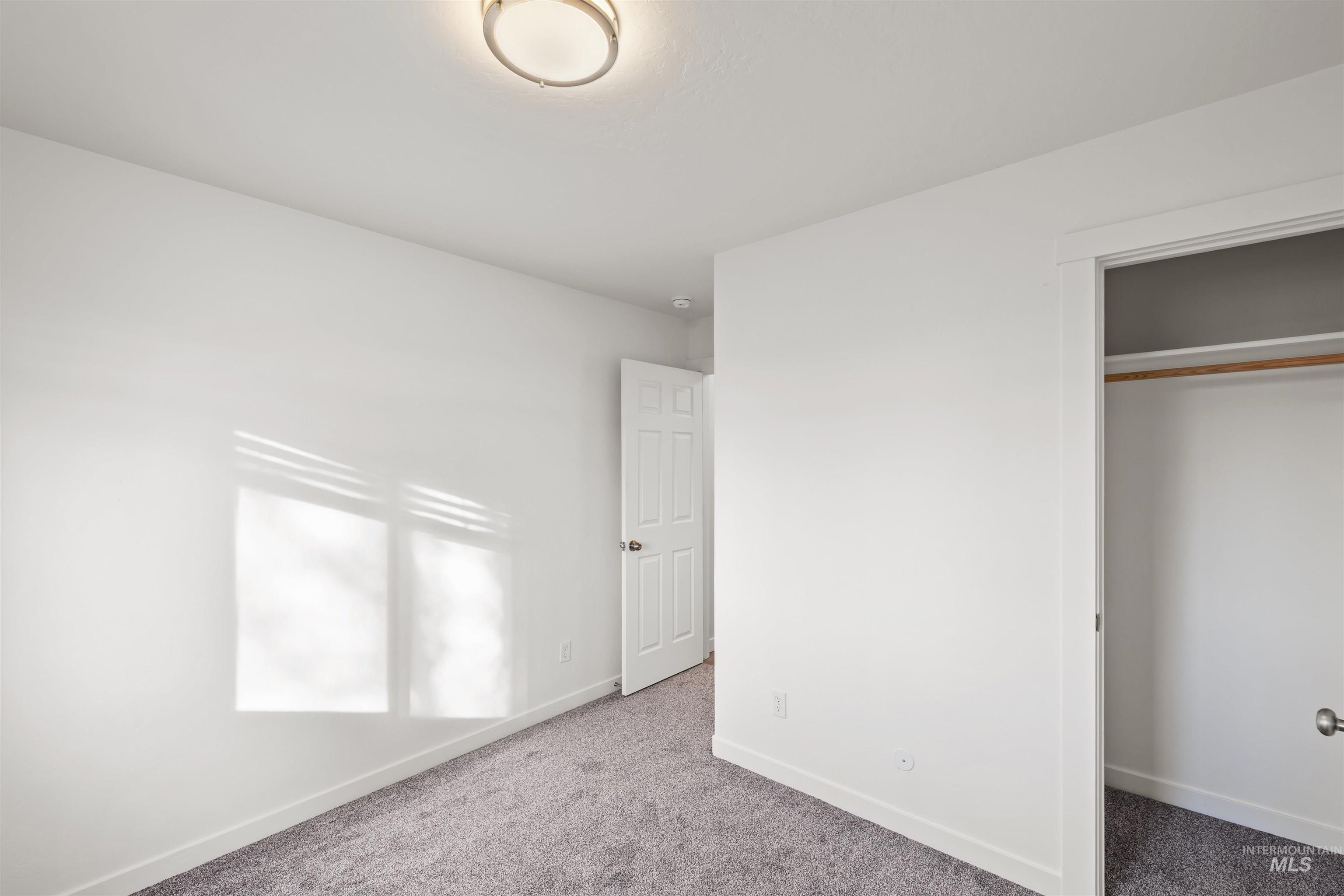 Unfurnished bedroom featuring carpet and a closet