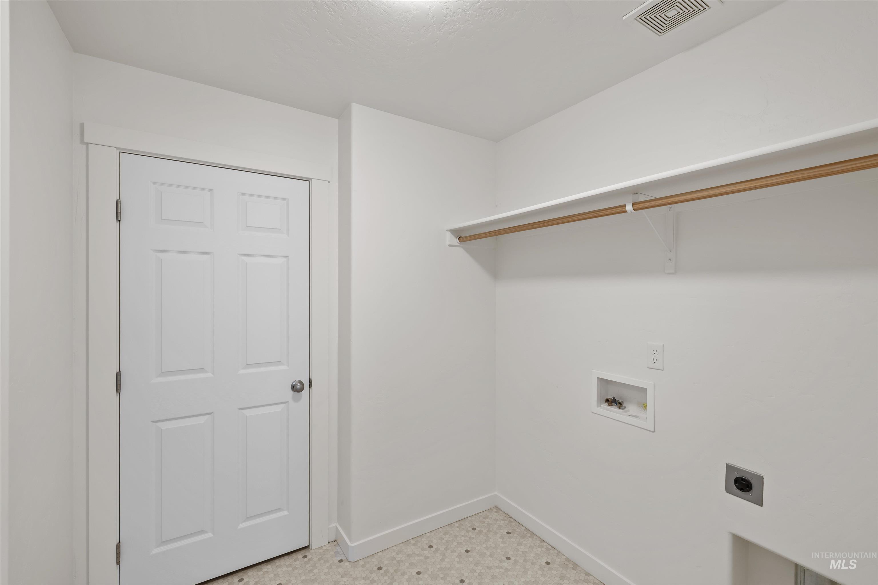 Laundry room featuring tile patterned floors, washer hookup, and electric dryer hookup