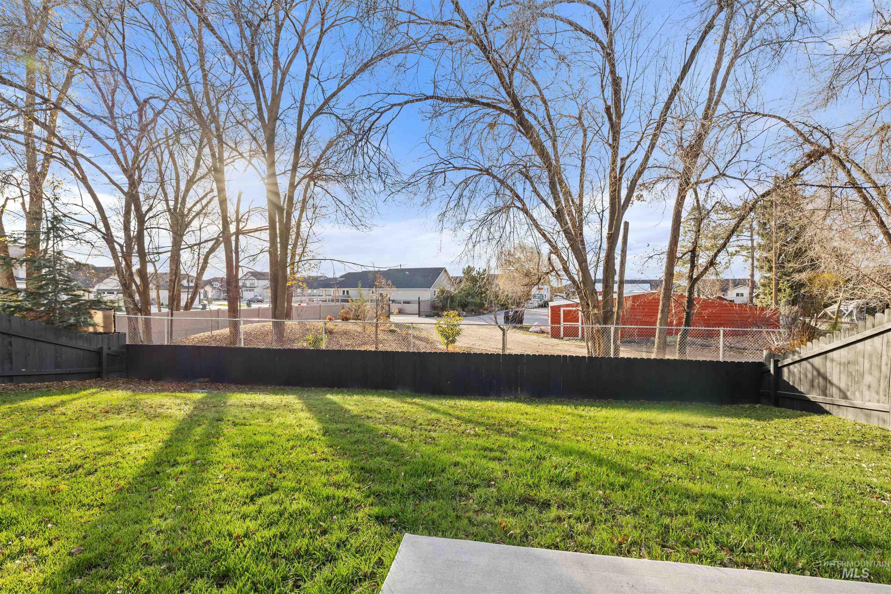 Fenced backyard with a residential view
