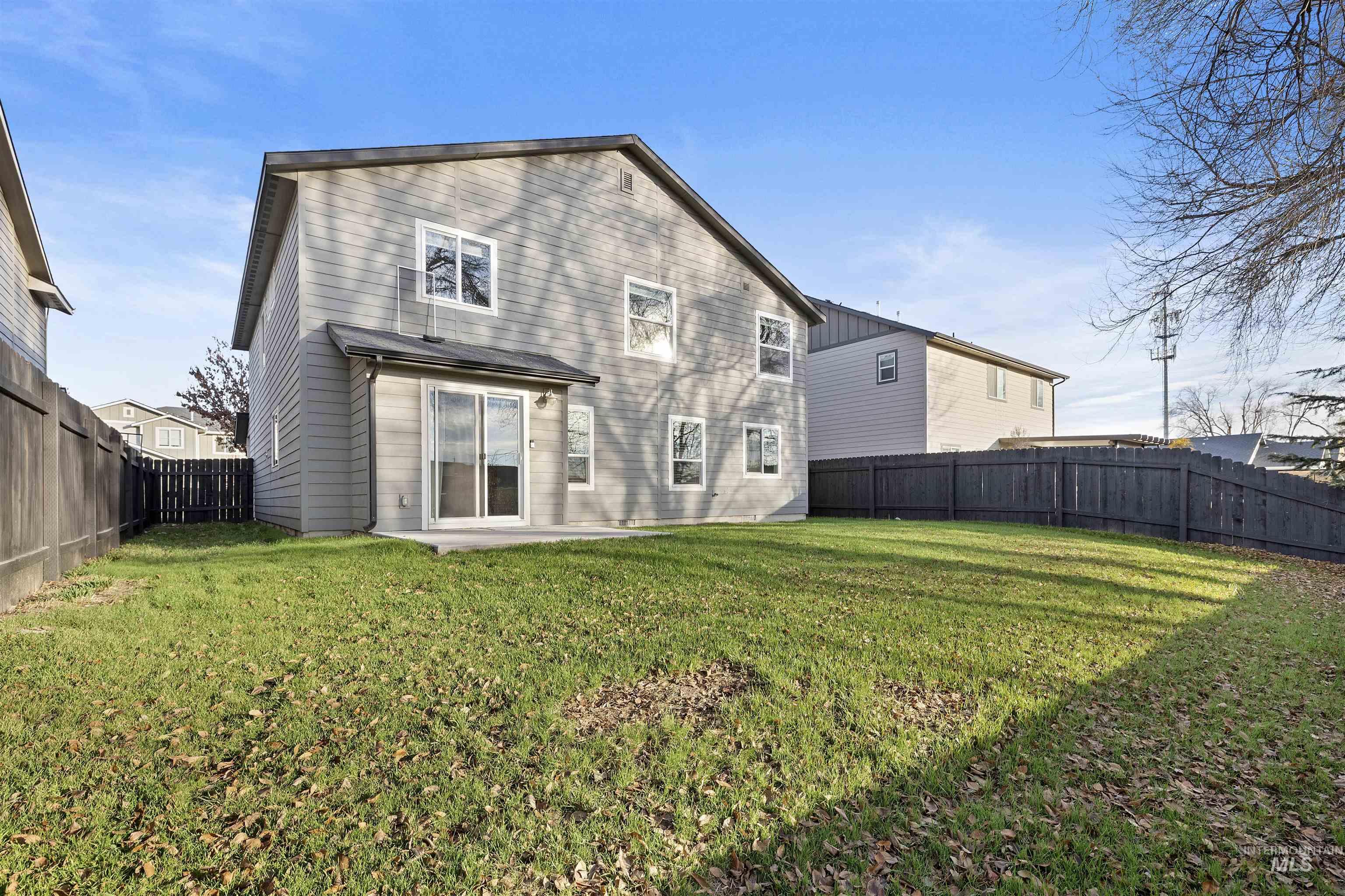 Back of house featuring a fenced backyard and a patio