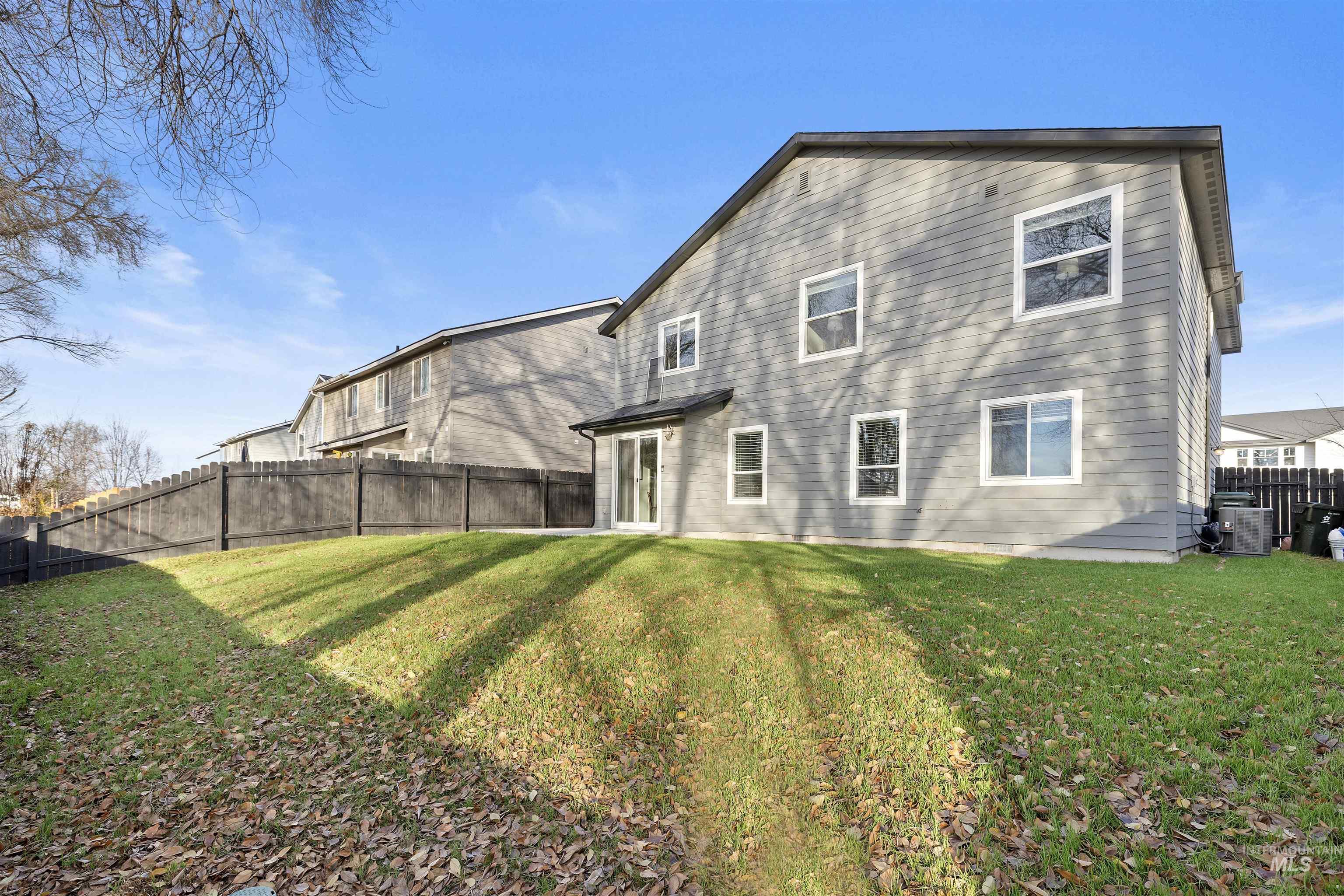 Rear view of house with a fenced backyard