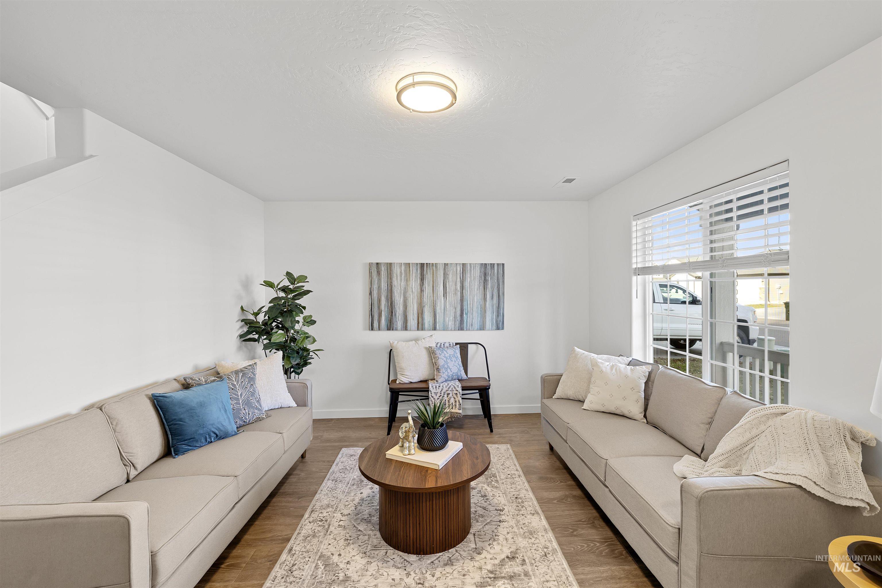 Living room featuring wood finished floors and a textured ceiling
