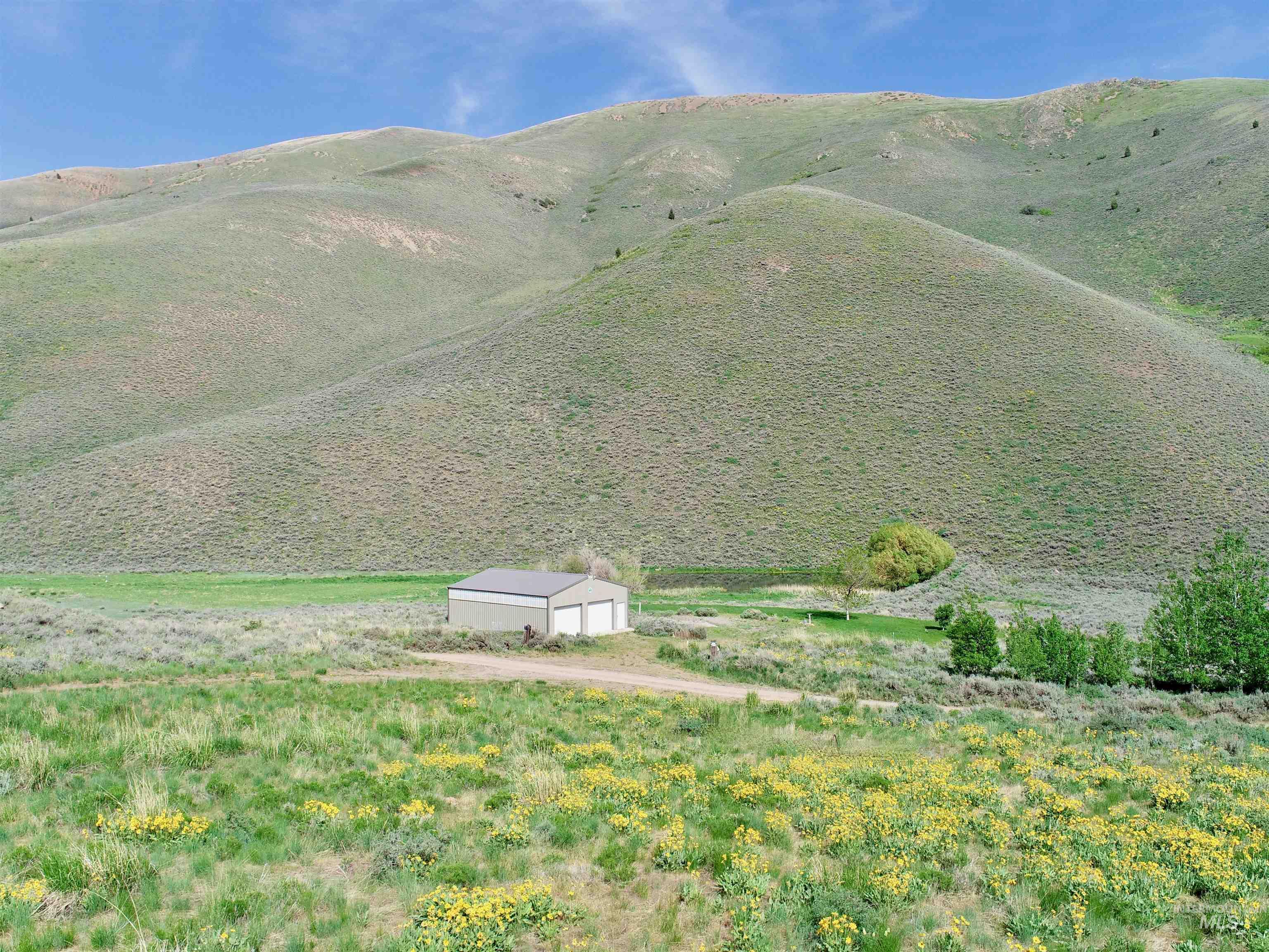 View of mountain backdrop featuring rural landscape