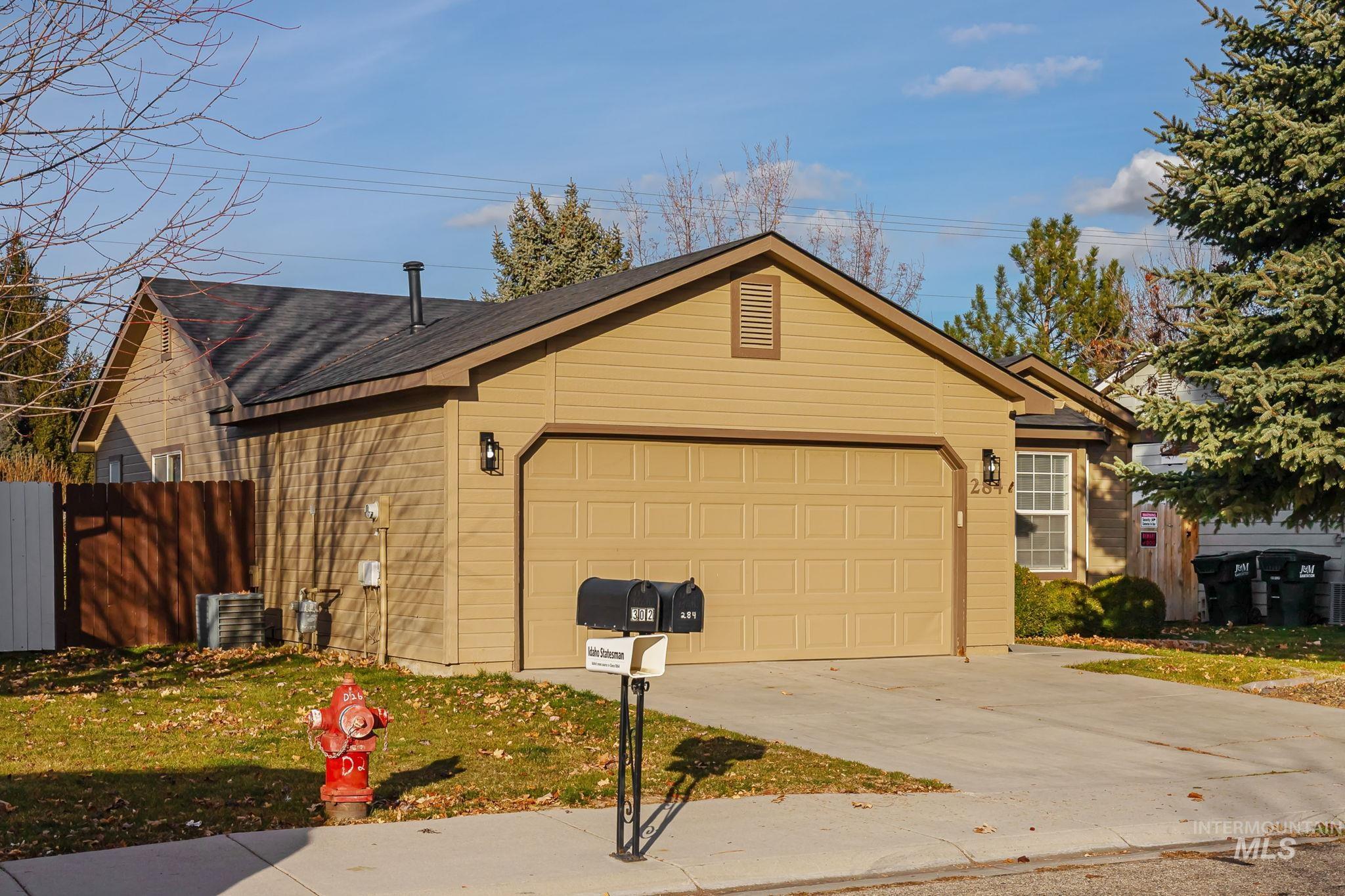 Ranch-style house featuring driveway and an attached garage