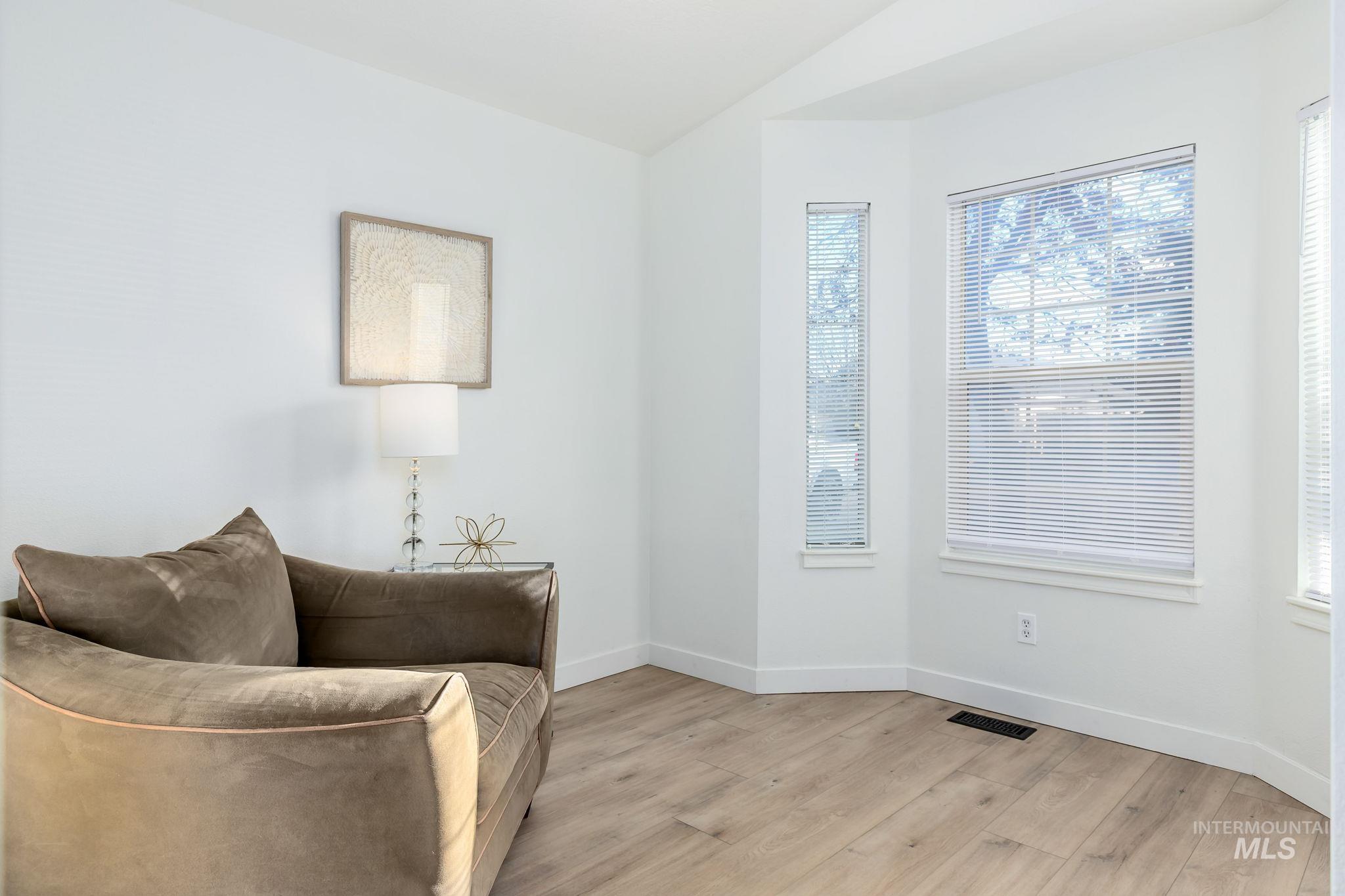 Living area with light wood-type flooring and plenty of natural light