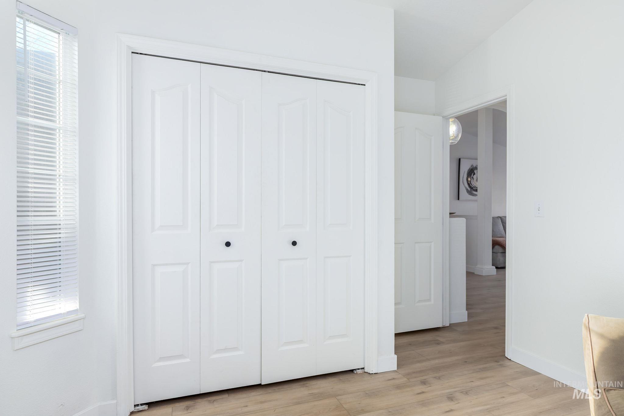 Bedroom with light wood-style floors and a closet