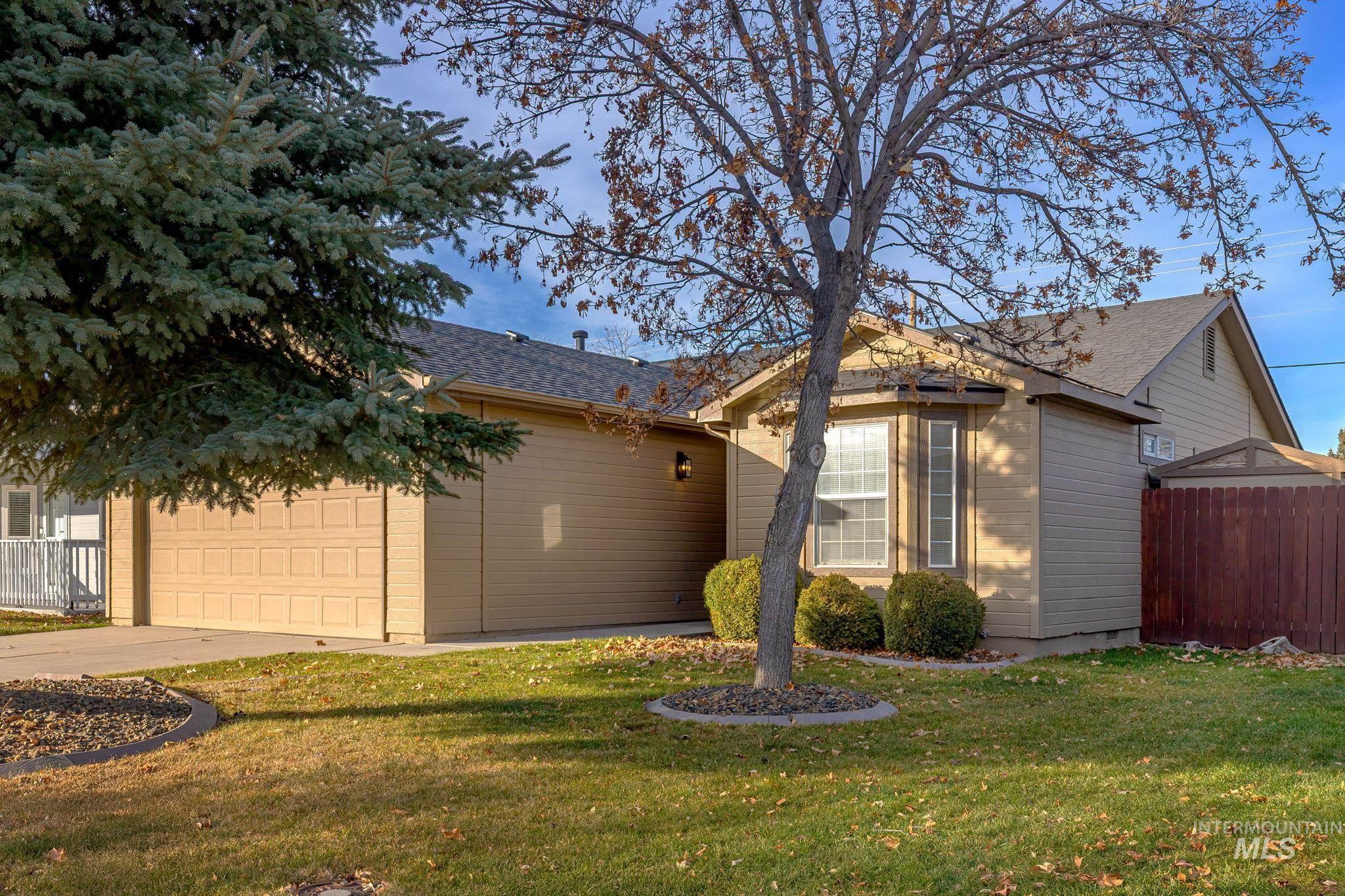 View of front facade with a garage, concrete driveway, and a shingled roof