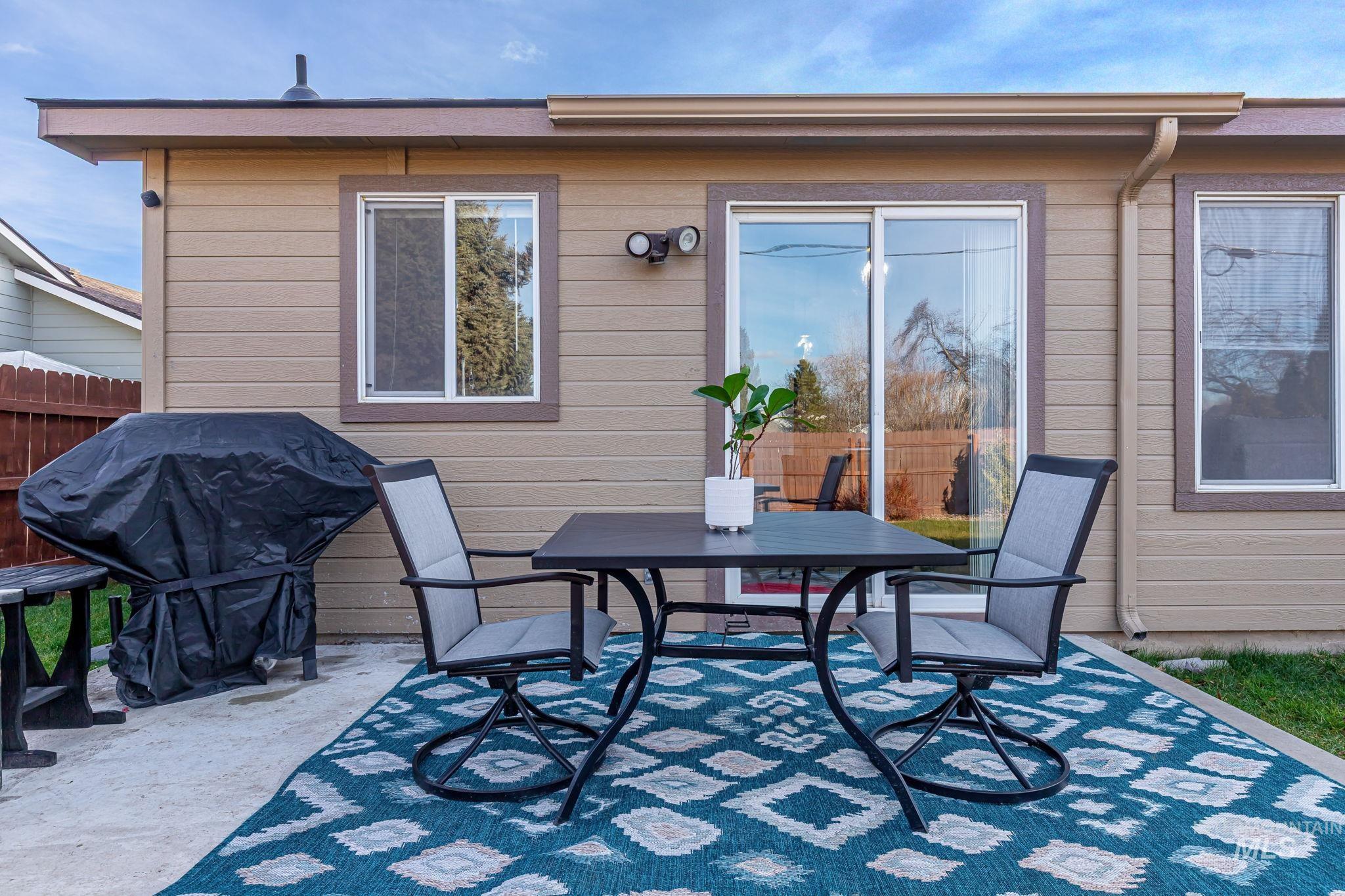 View of patio with grilling area and outdoor dining area