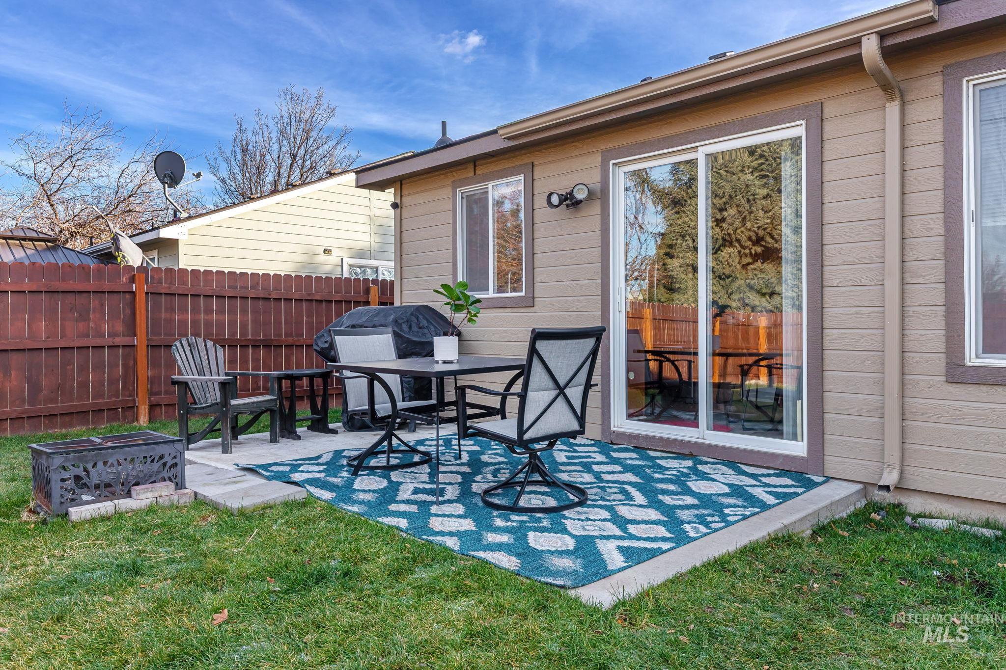 View of patio with a grill and an outdoor fire pit