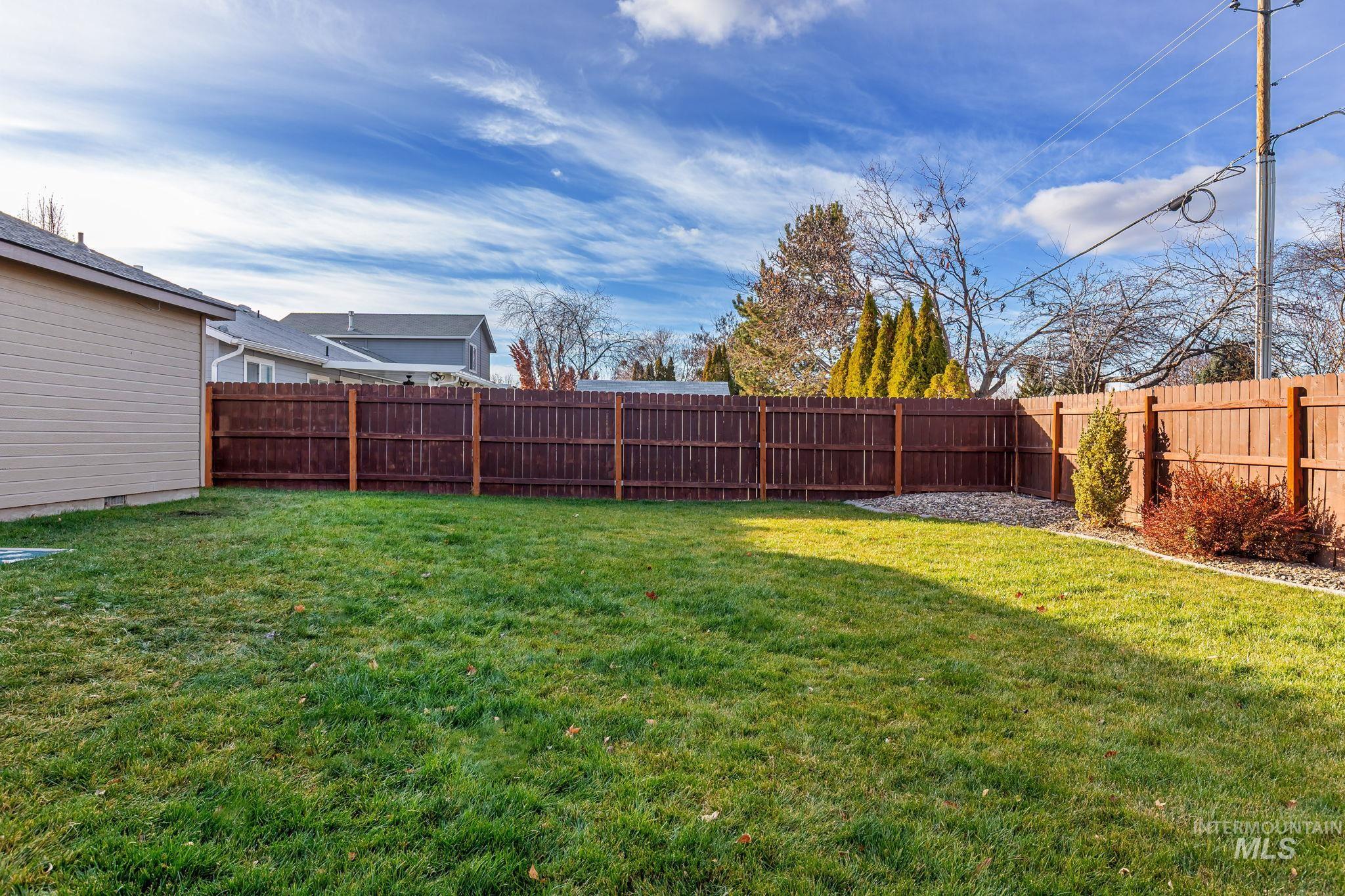 View of fenced backyard